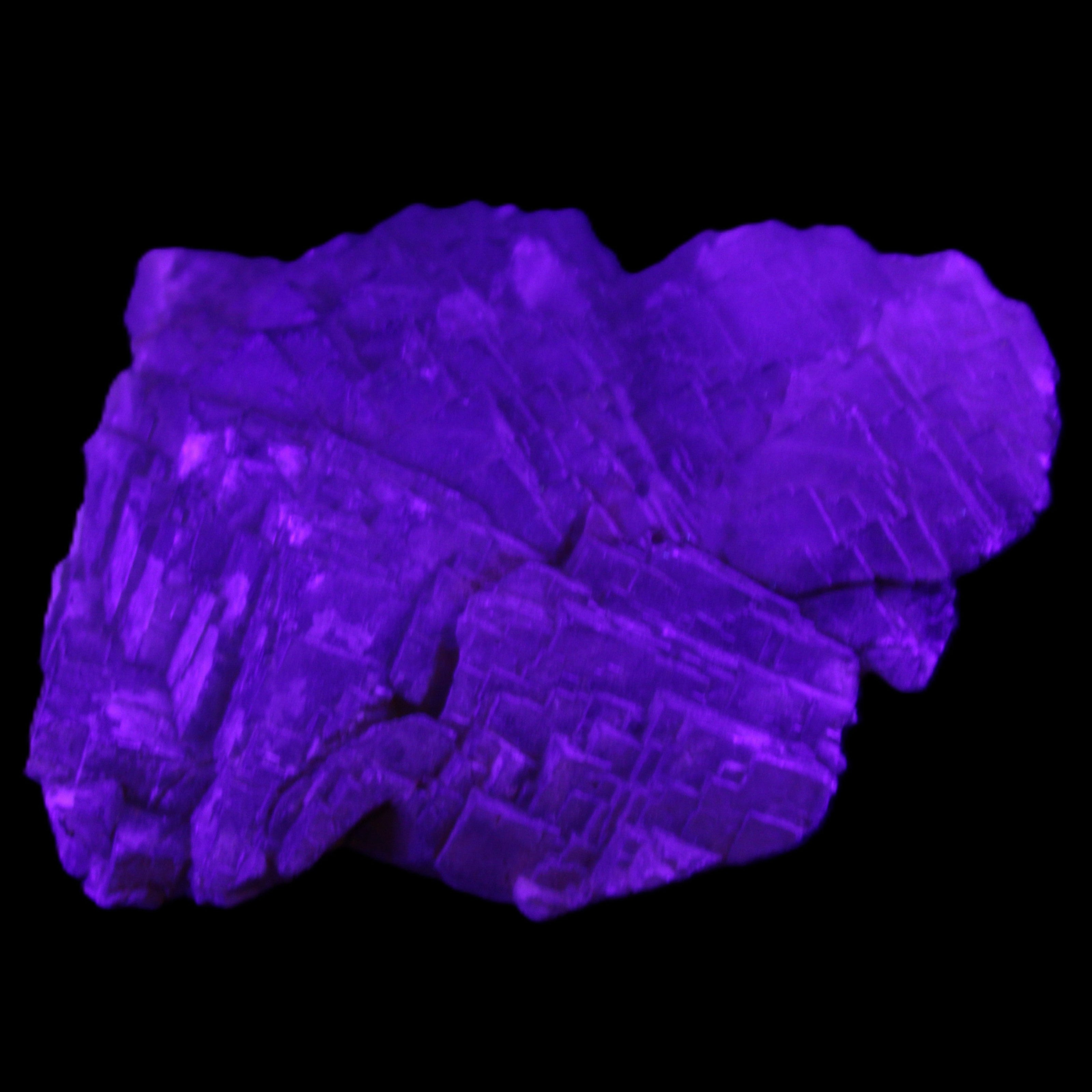 Clear Fluorite stepped cluster 87*80*28mm 238g in UV light - Rocks and Things Store