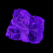 Clear Fluorite cubic cluster 62*60*28mm 104g in UV light - Rocks and Things Store