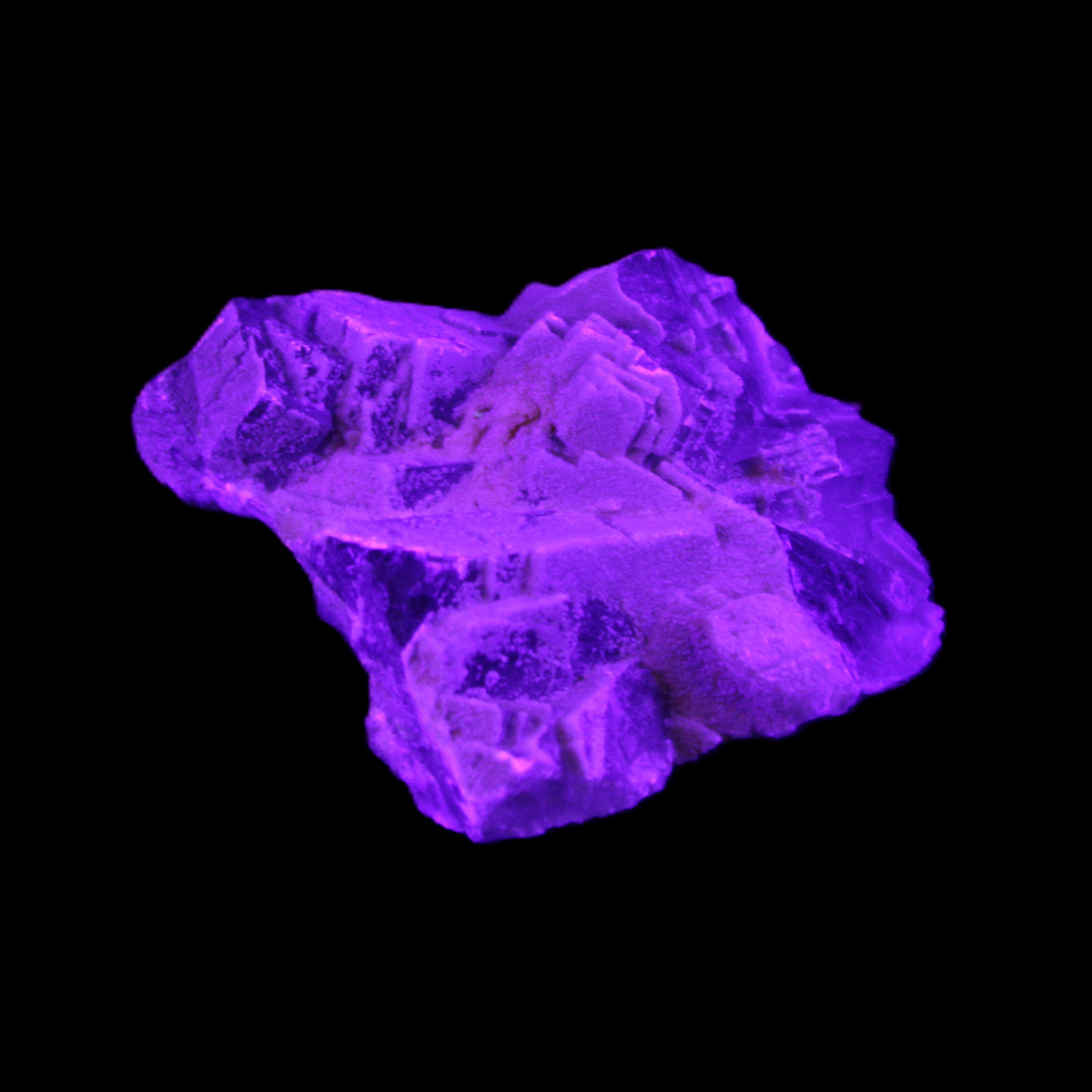 Clear Fluorite cubic cluster 62*60*28mm 104g in UV light - Rocks and Things Store