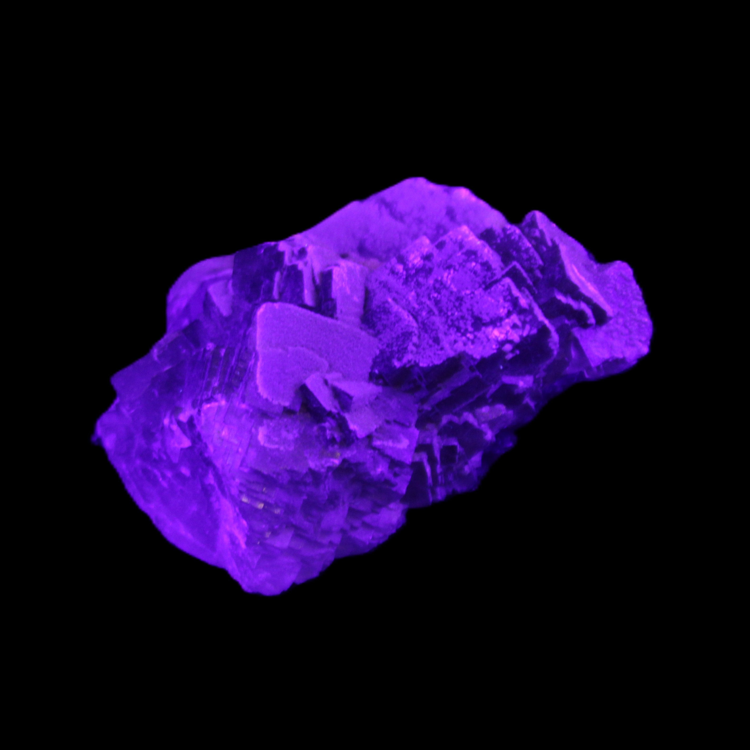 Clear Fluorite cubic cluster 62*60*28mm 104g in UV light - Rocks and Things Store