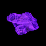 Clear Fluorite cubic cluster 62*60*28mm 104g in UV light - Rocks and Things Store
