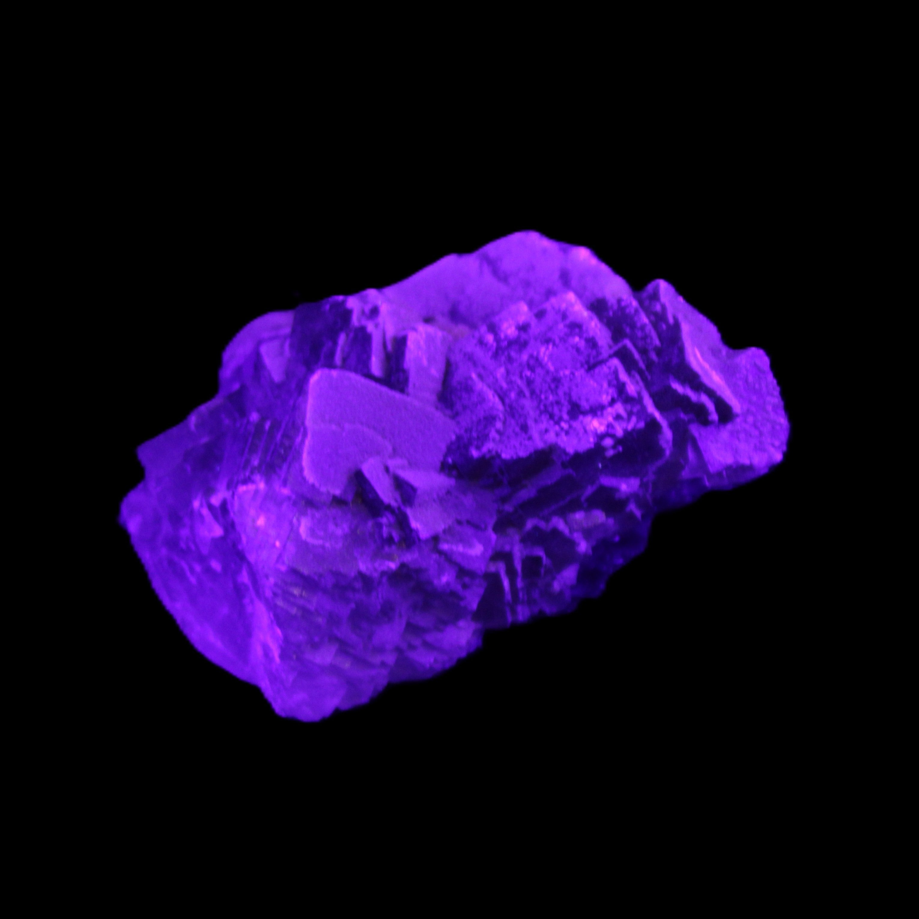 Clear Fluorite cubic cluster 62*60*28mm 104g in UV light - Rocks and Things Store