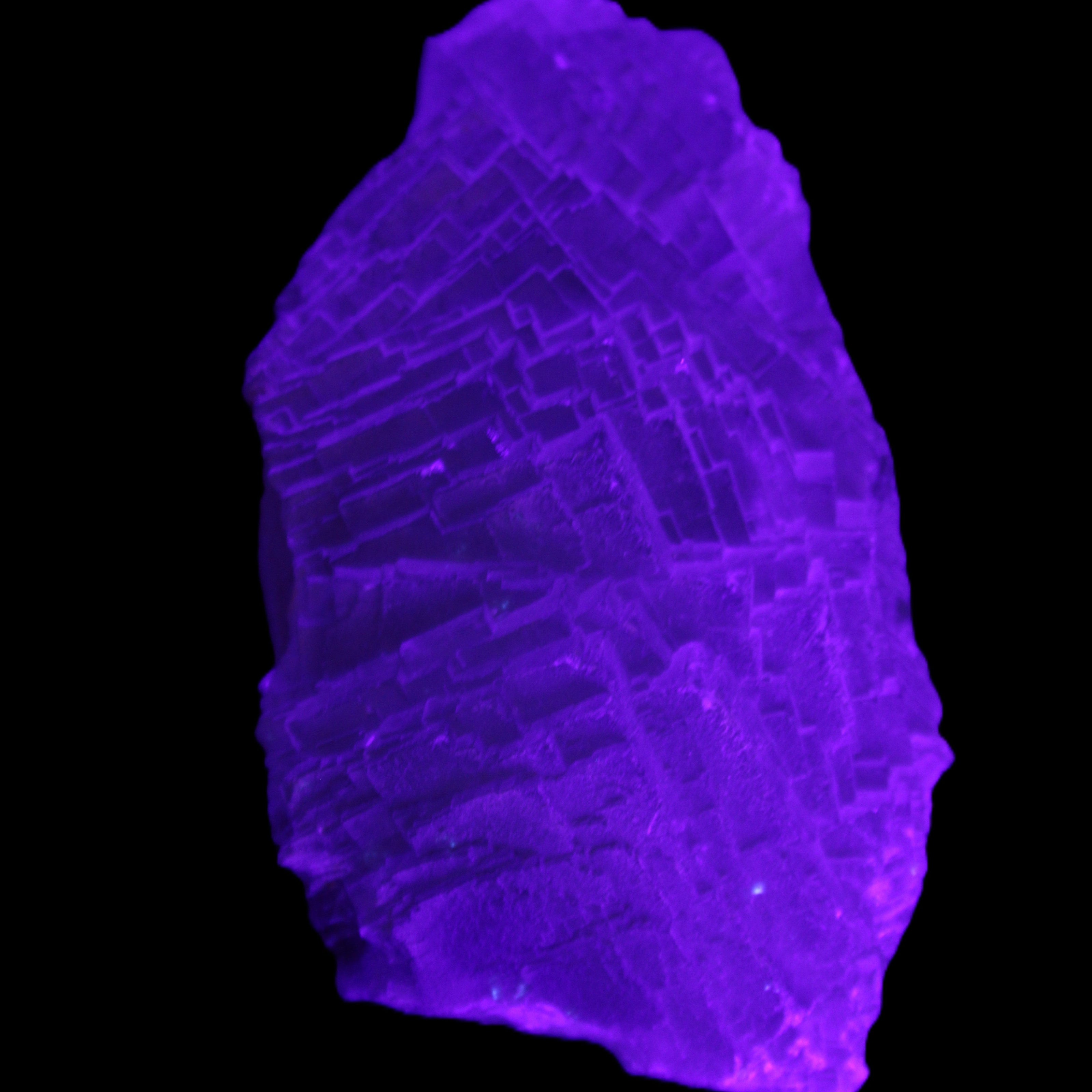 Clear Blue Fluorite cluster 105*55*50mm 487g in UV light - Rocks and Things Store