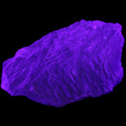 Clear Blue Fluorite cluster 105*55*50mm 487g in UV light - Rocks and Things Store