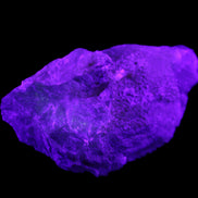 Clear Blue Fluorite cluster 105*55*50mm 487g in UV light - Rocks and Things Store