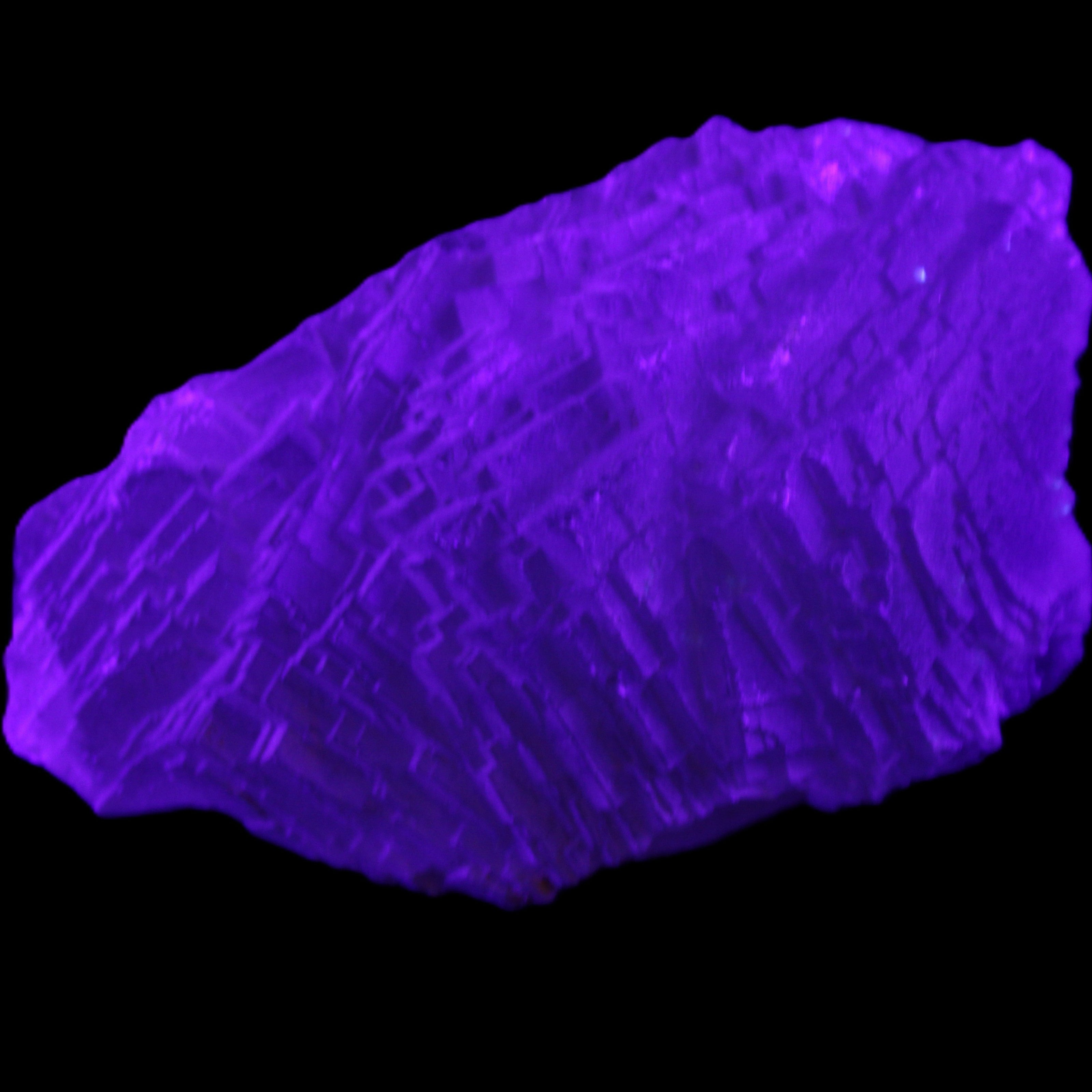 Clear Blue Fluorite cluster 105*55*50mm 487g in UV light - Rocks and Things Store