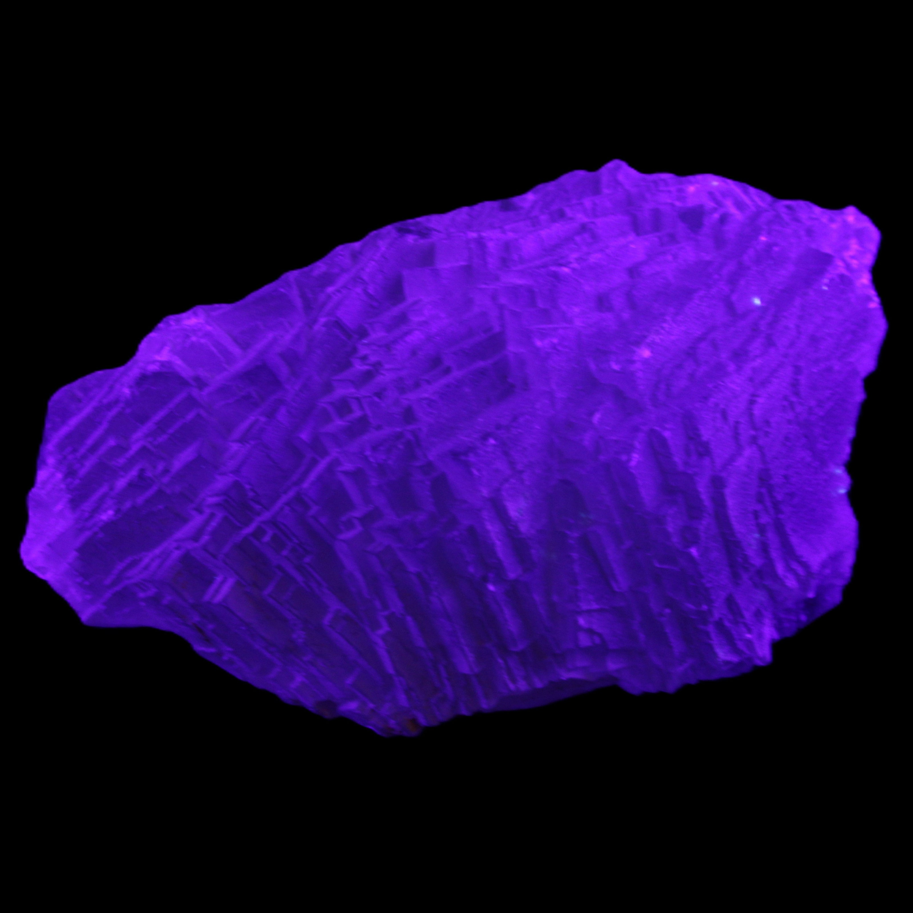 Clear Blue Fluorite cluster 105*55*50mm 487g in UV light - Rocks and Things Store