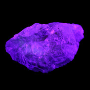Clear Blue Fluorite cluster 105*55*50mm 487g in UV light - Rocks and Things Store
