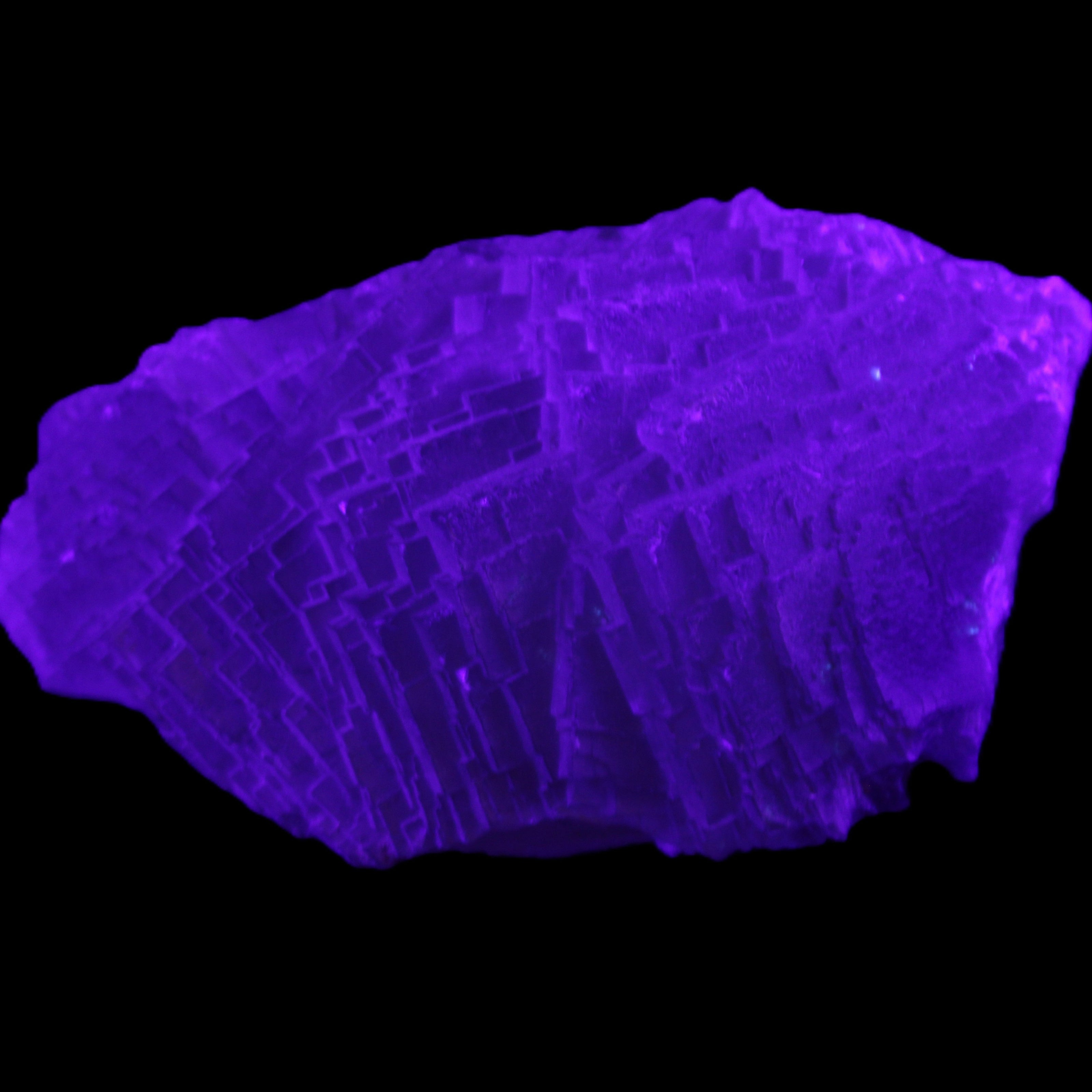 Clear Blue Fluorite cluster 105*55*50mm 487g in UV light - Rocks and Things Store