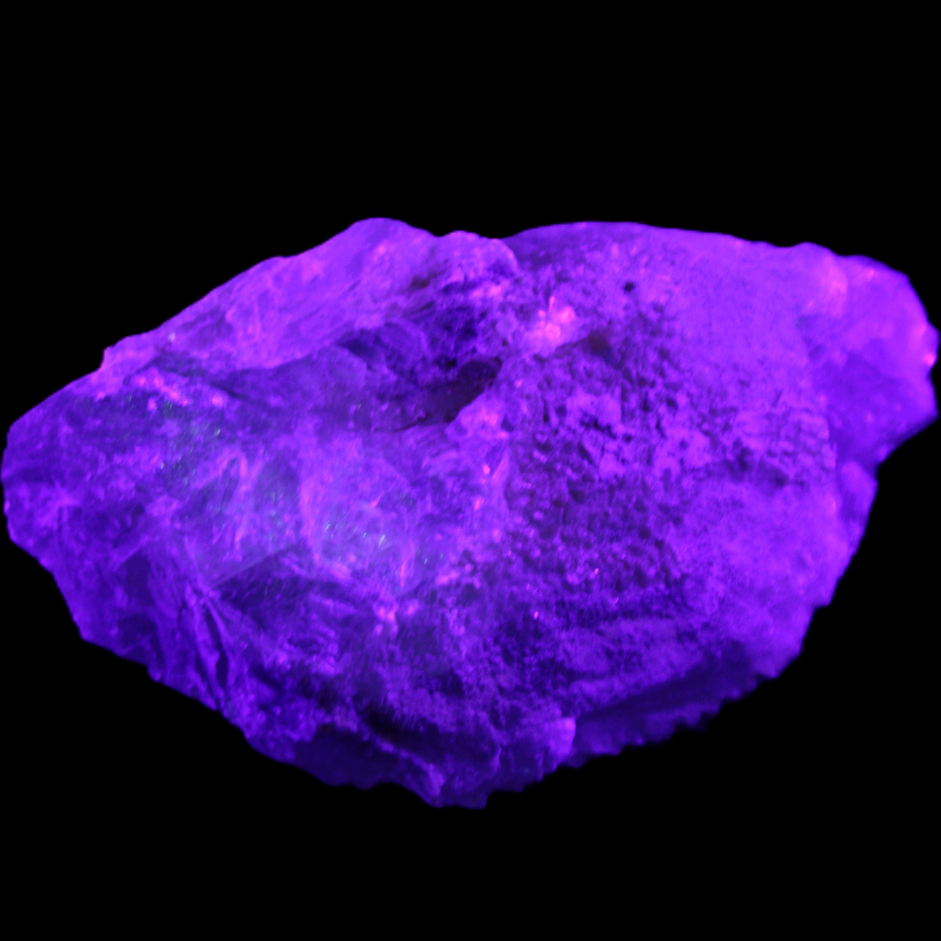 Clear Blue Fluorite cluster 105*55*50mm 487g in UV light - Rocks and Things Store