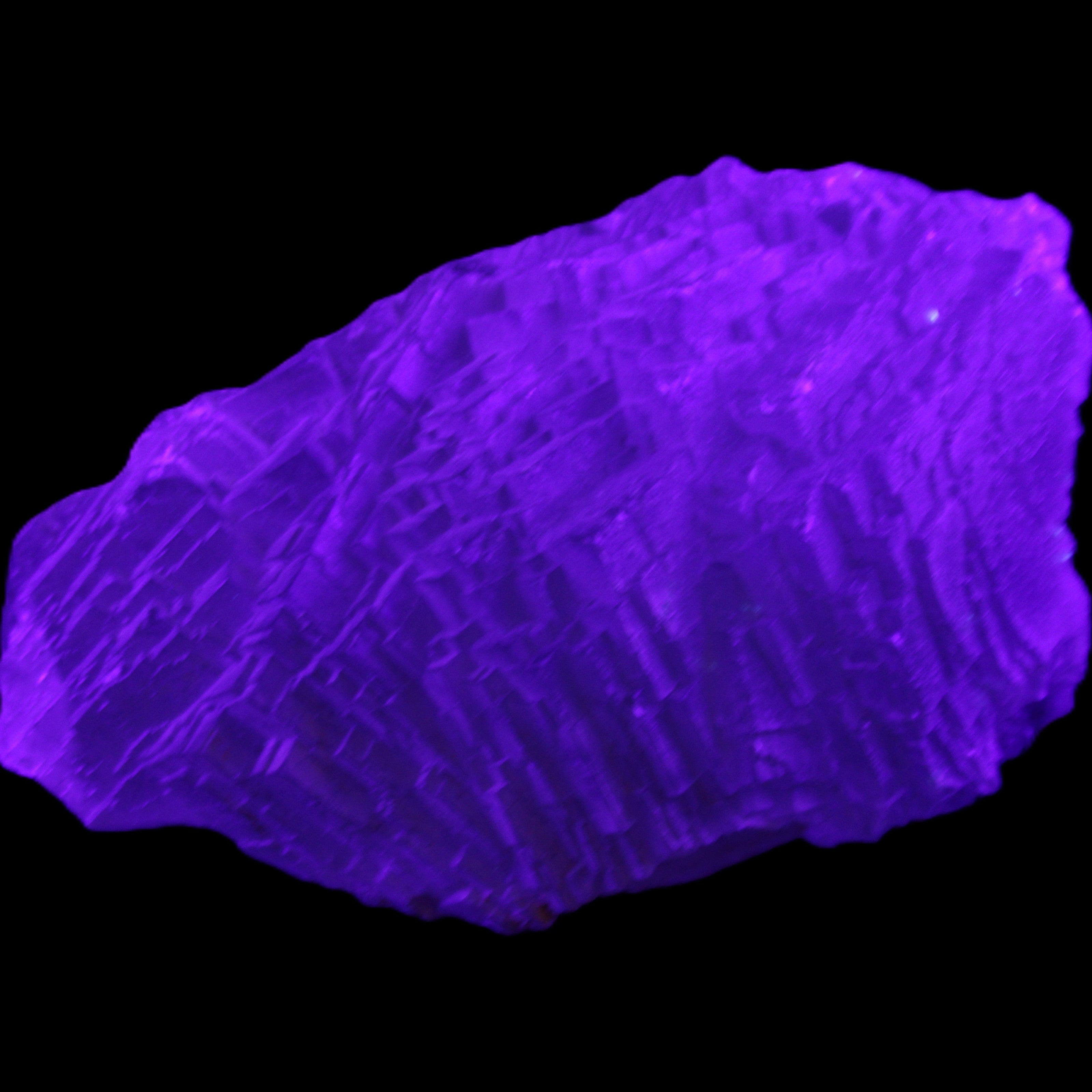 Clear Blue Fluorite cluster 105*55*50mm 487g in UV light - Rocks and Things Store