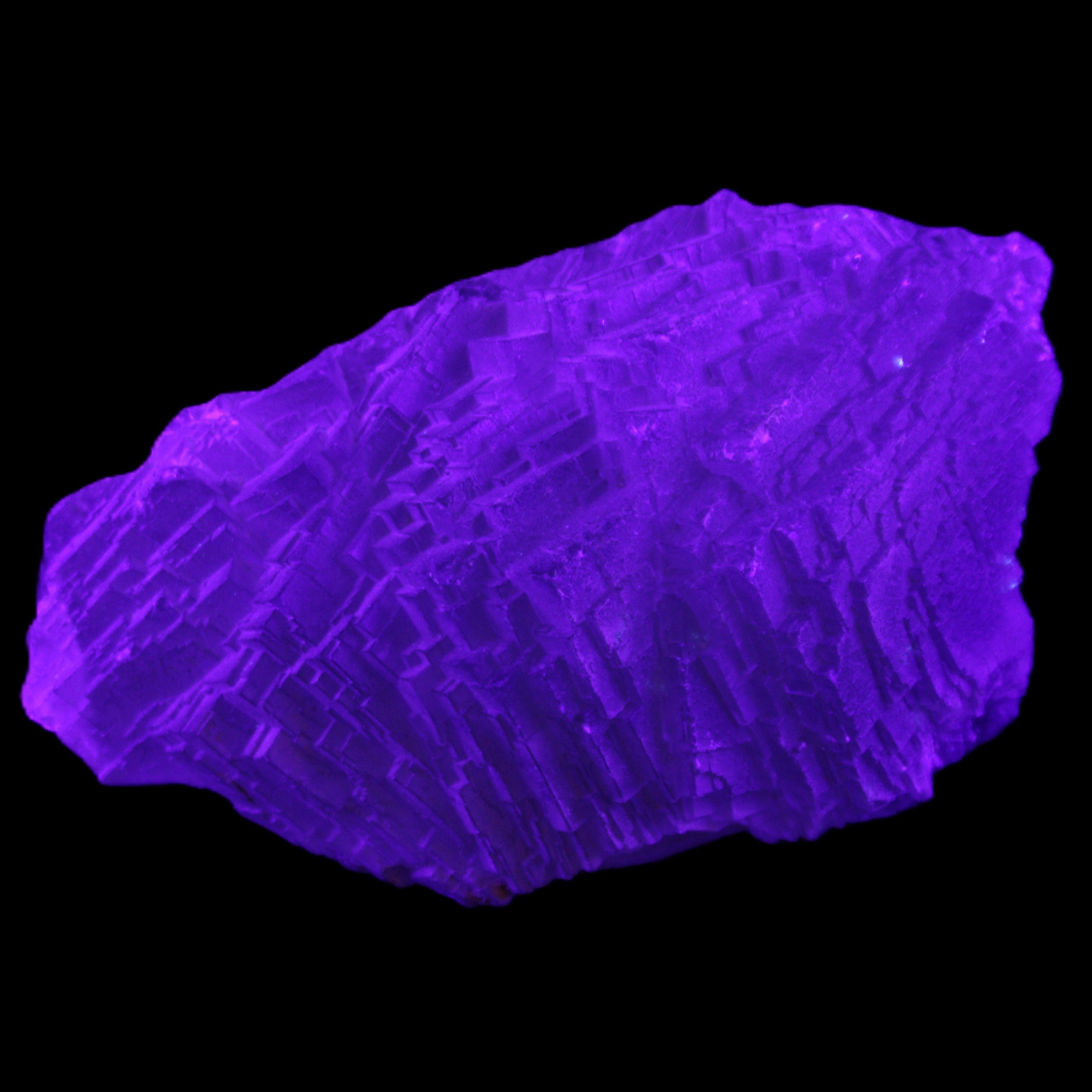 Clear Blue Fluorite cluster 105*55*50mm 487g in UV light - Rocks and Things Store