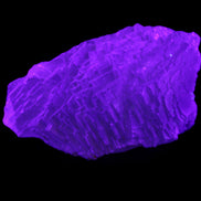 Clear Blue Fluorite cluster 105*55*50mm 487g in UV light - Rocks and Things Store
