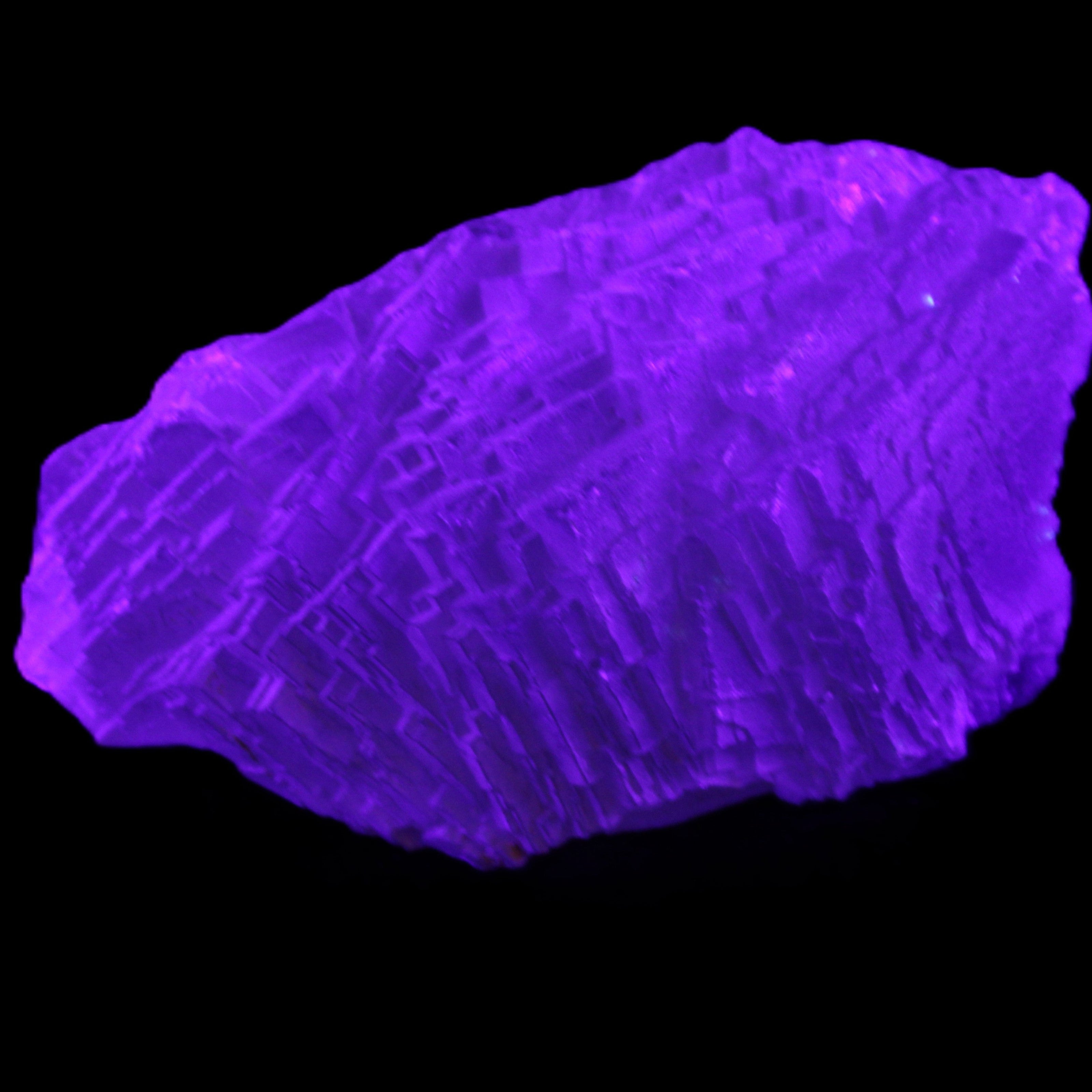 Clear Blue Fluorite cluster 105*55*50mm 487g in UV light - Rocks and Things Store