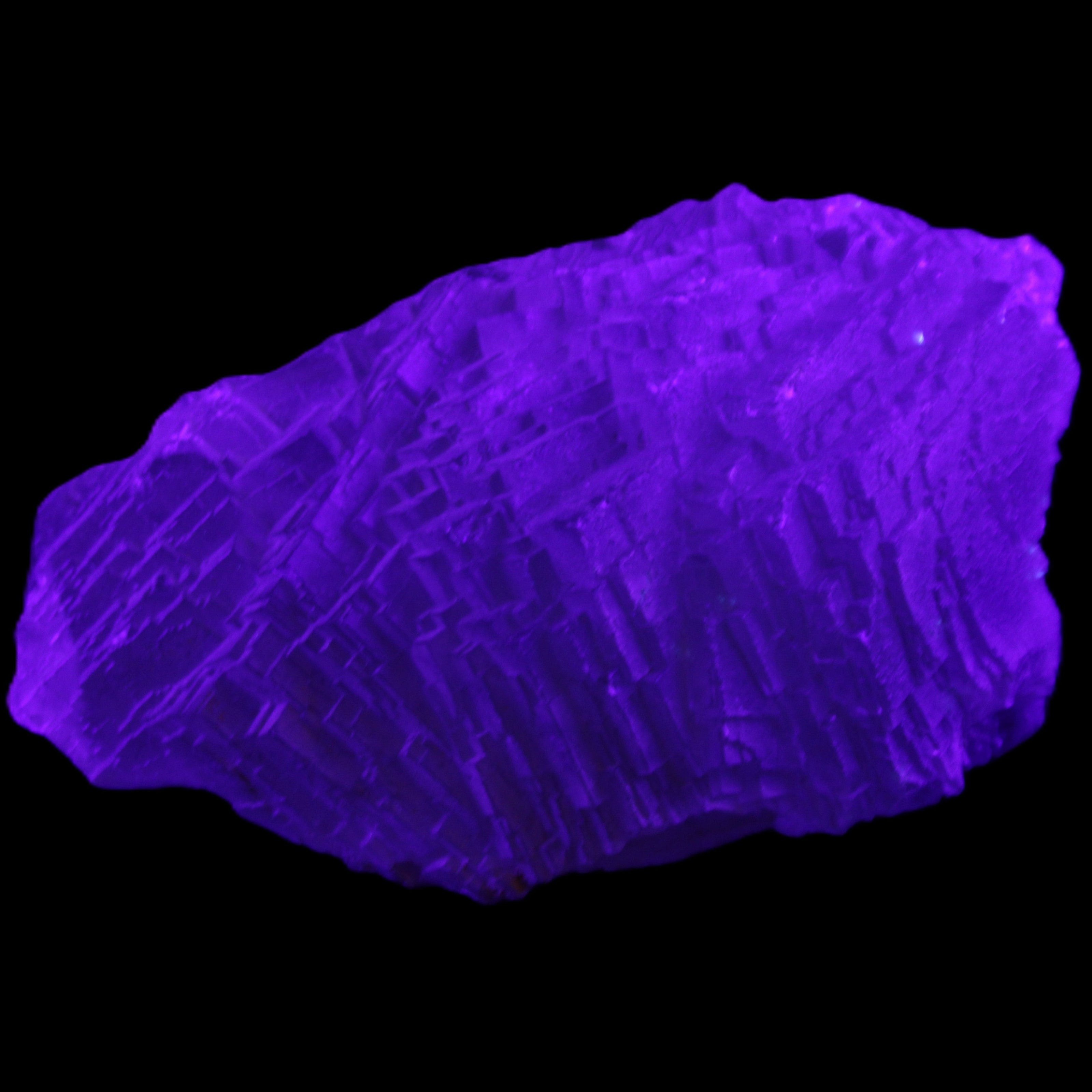 Clear Blue Fluorite cluster 105*55*50mm 487g in UV light - Rocks and Things Store