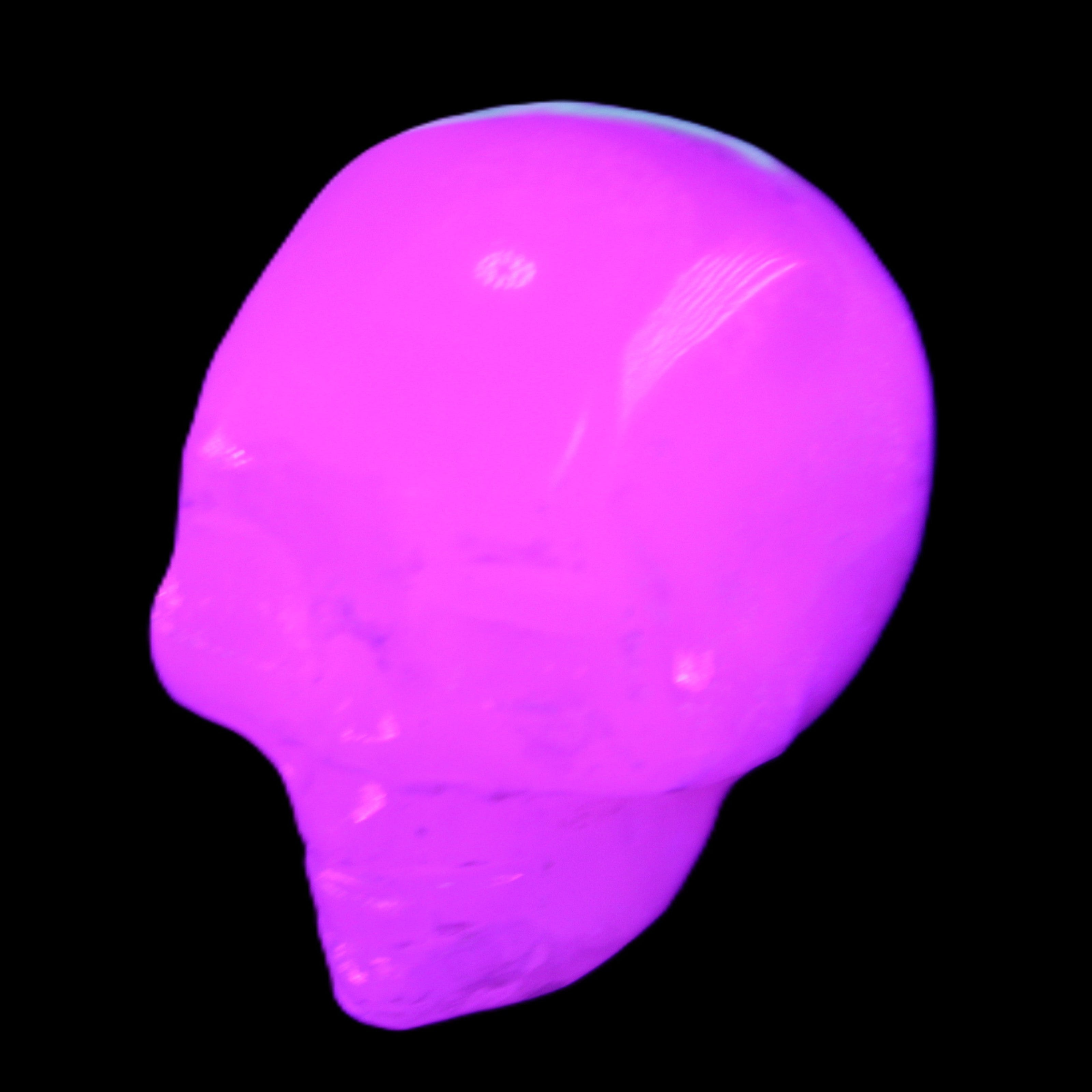 Mangano Calcite skull 35*47*40mm 117g in UV light - Rocks and Things Store