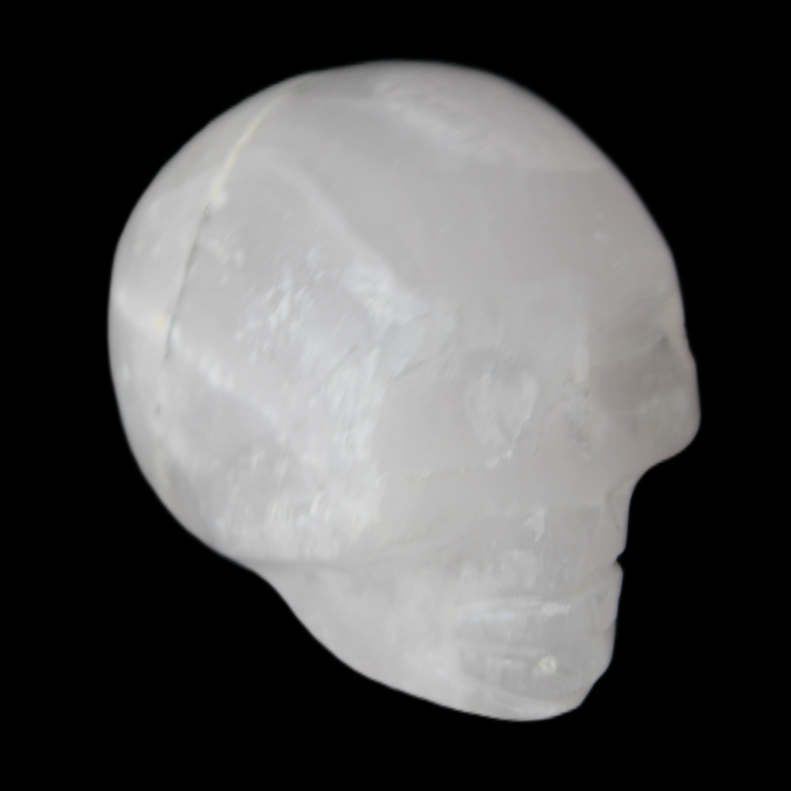Mangano Calcite skull 35*47*40mm 117g in sunlight - Rocks and Things Store