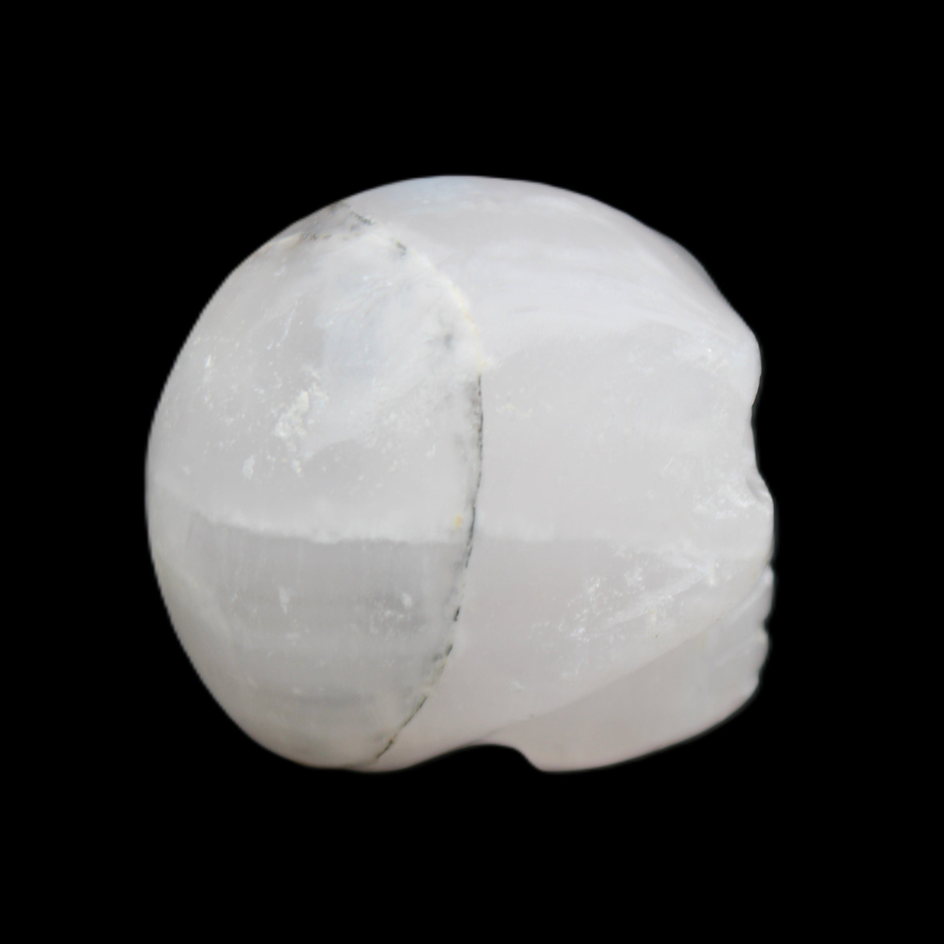 Mangano Calcite skull 35*47*40mm 117g in sunlight - Rocks and Things Store