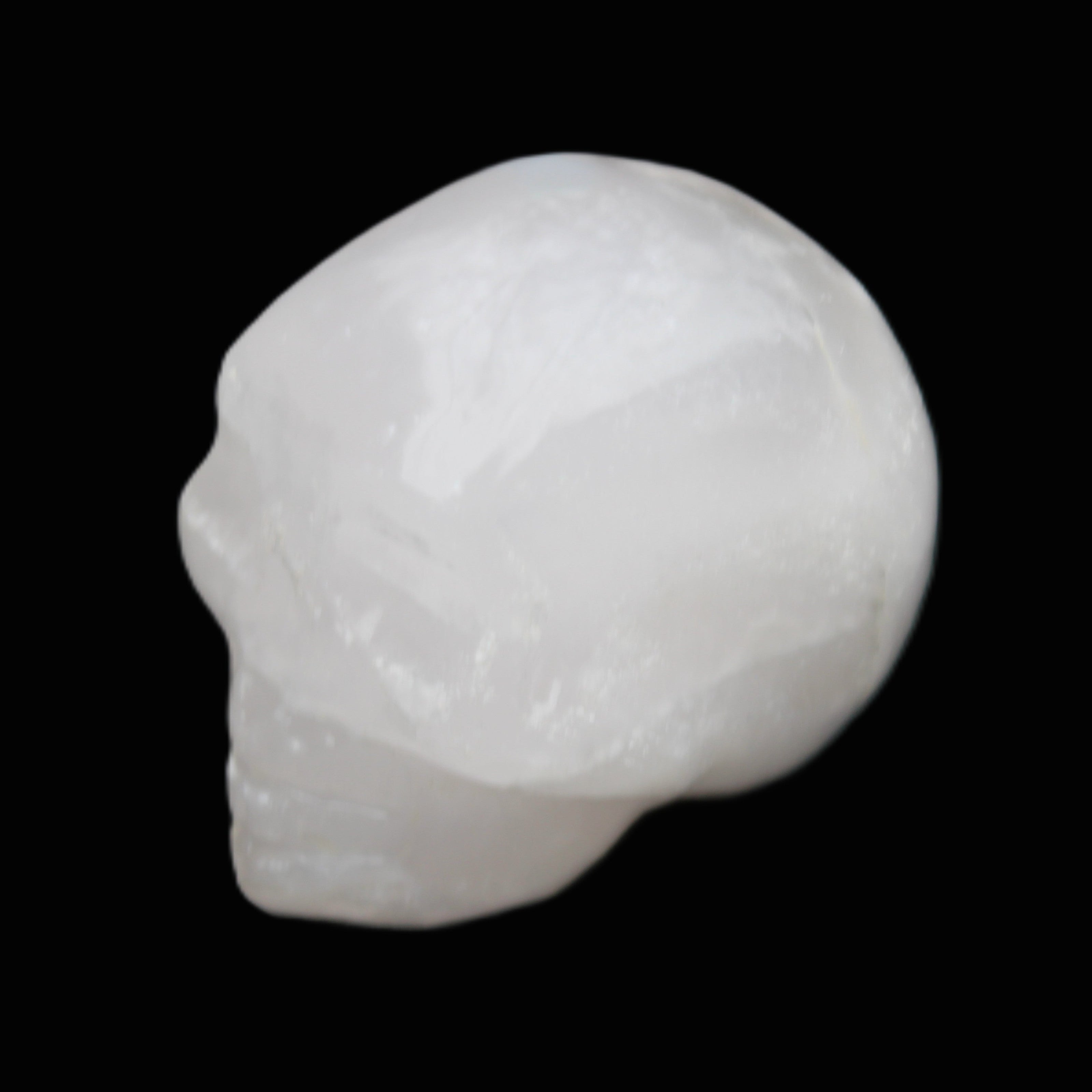 Mangano Calcite skull 35*47*40mm 117g in sunlight - Rocks and Things Store