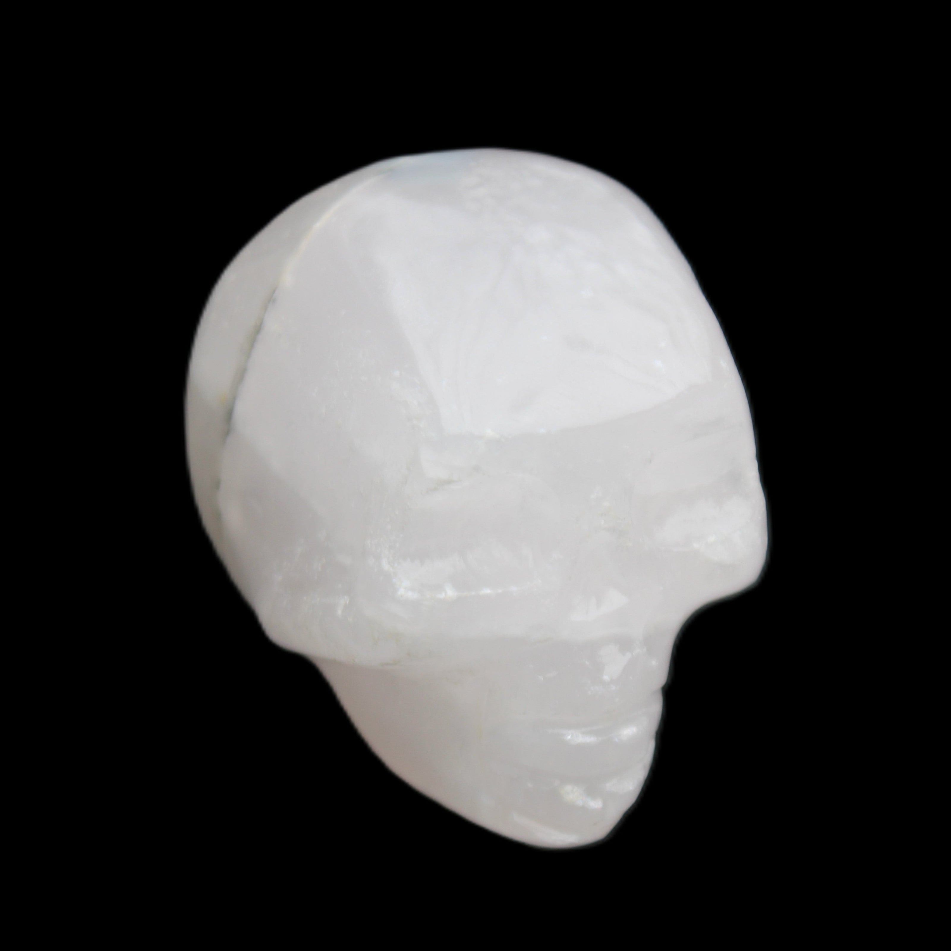 Mangano Calcite skull 35*47*40mm 117g in sunlight - Rocks and Things Store