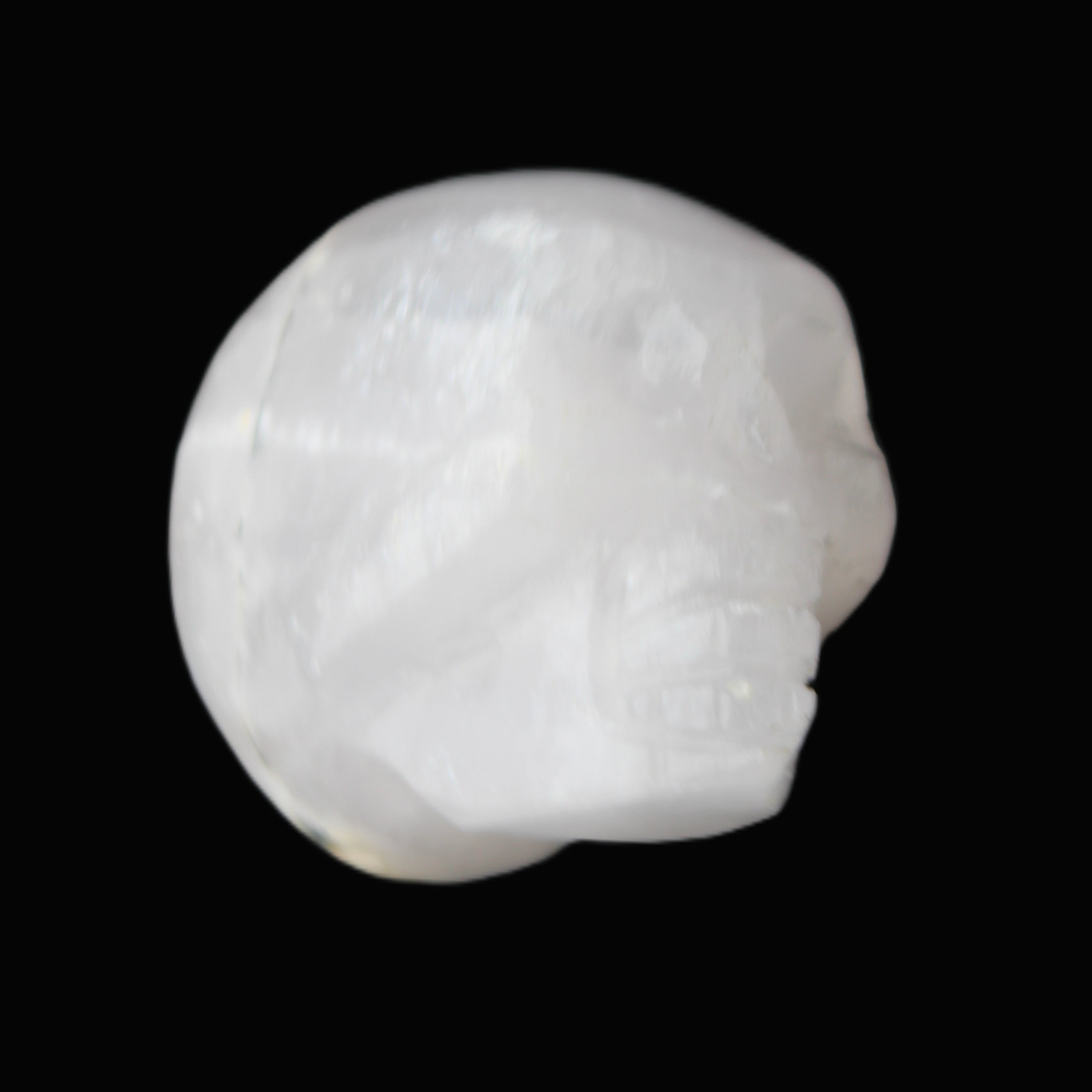 Mangano Calcite skull 35*47*40mm 117g in sunlight - Rocks and Things Store