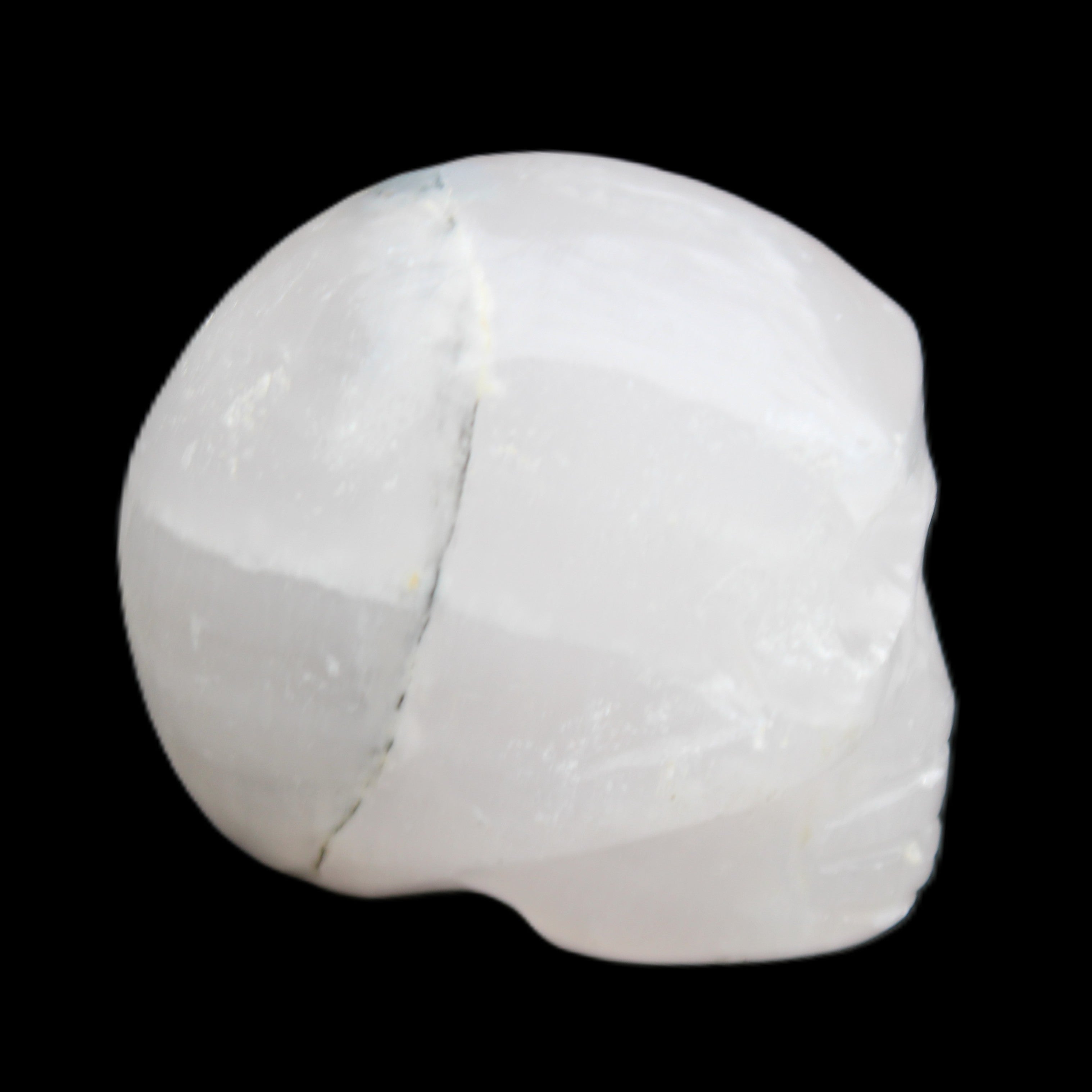 Mangano Calcite skull 35*47*40mm 117g in sunlight - Rocks and Things Store