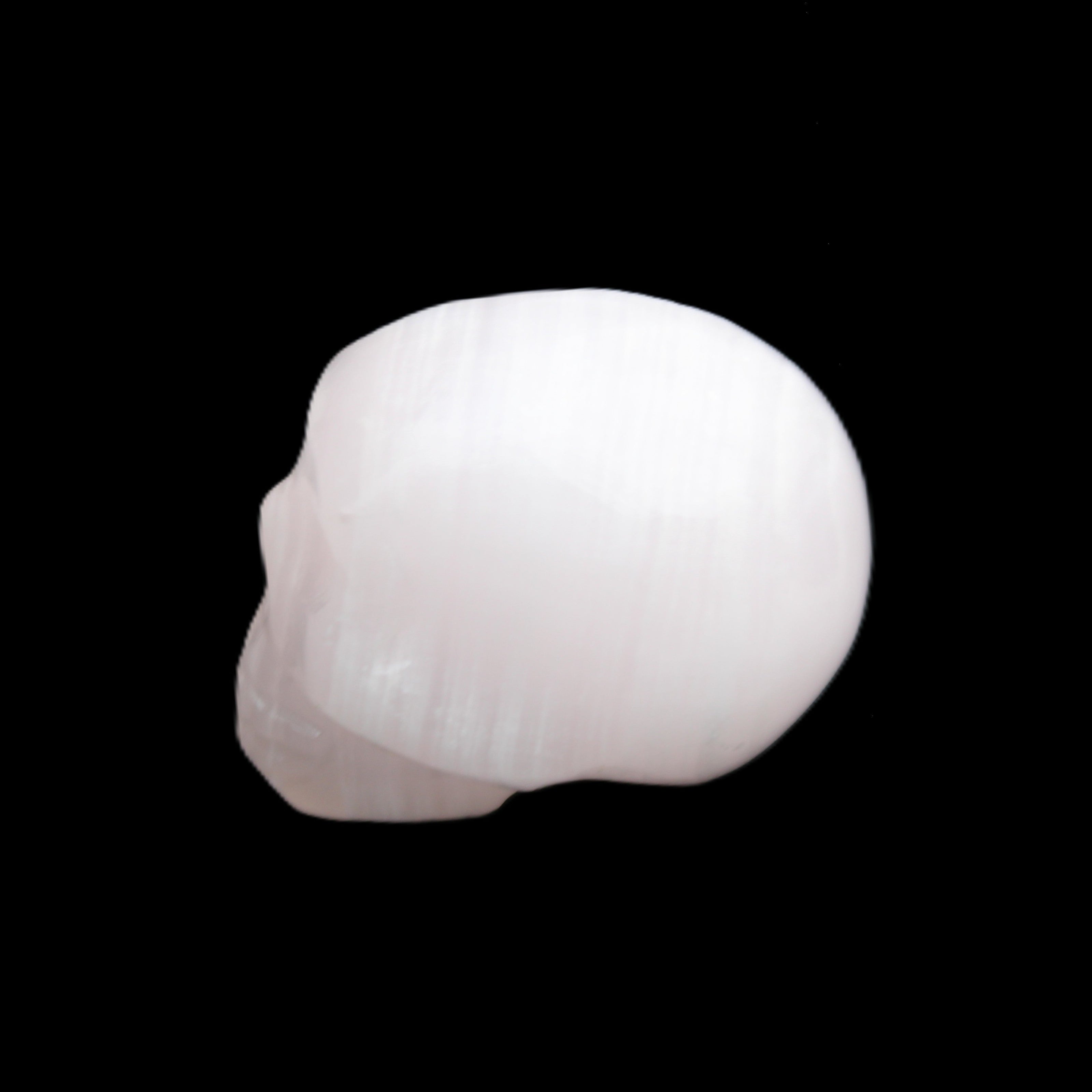 Mangano Calcite skull 24*38*32mm 48g in sunlight - Rocks and Things Store