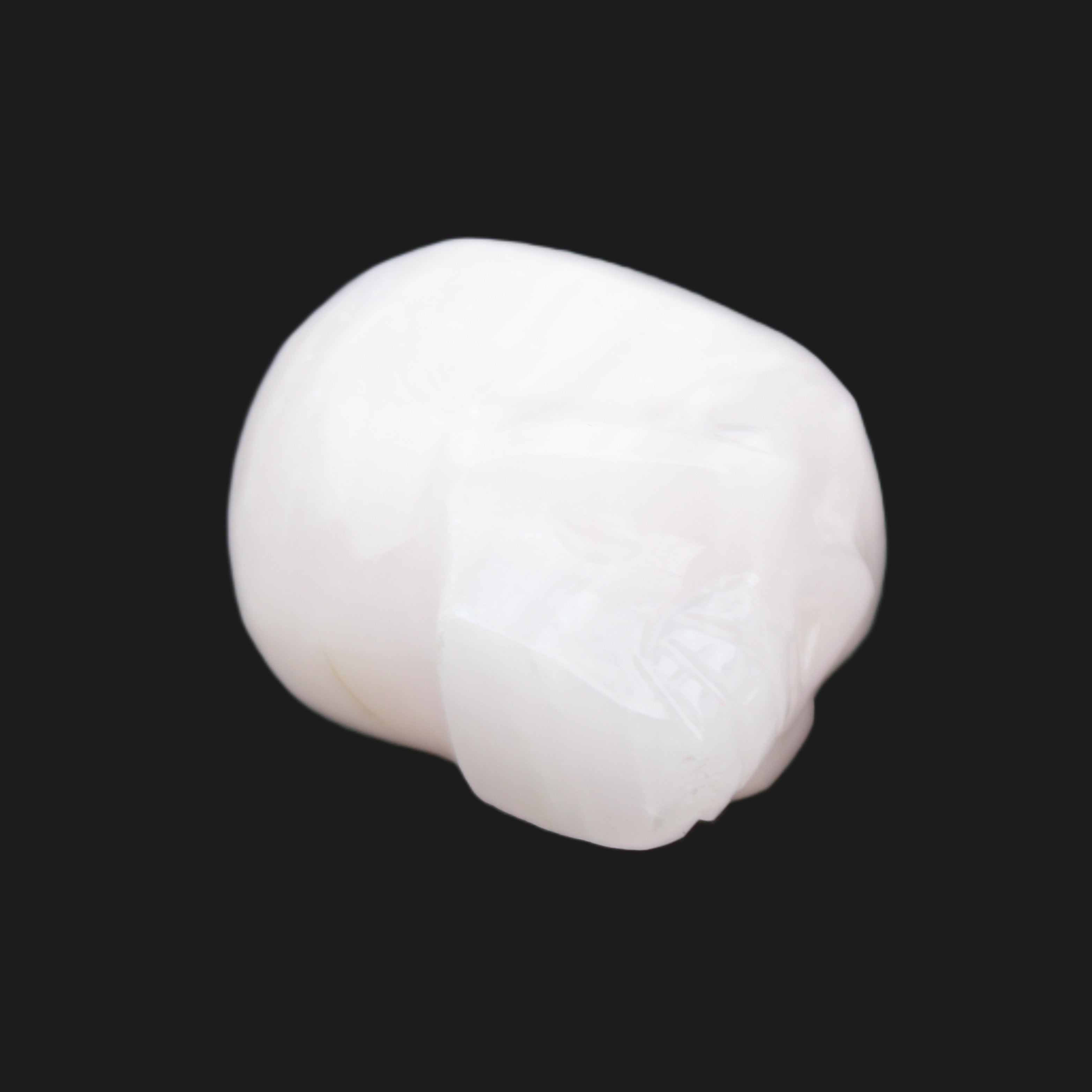 Mangano Calcite skull 24*38*32mm 48g in sunlight - Rocks and Things Store