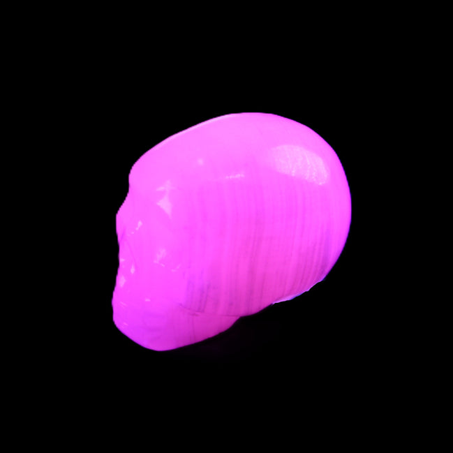 Mangano Calcite skull 24*38*32mm 48g in UV light - Rocks and Things Store