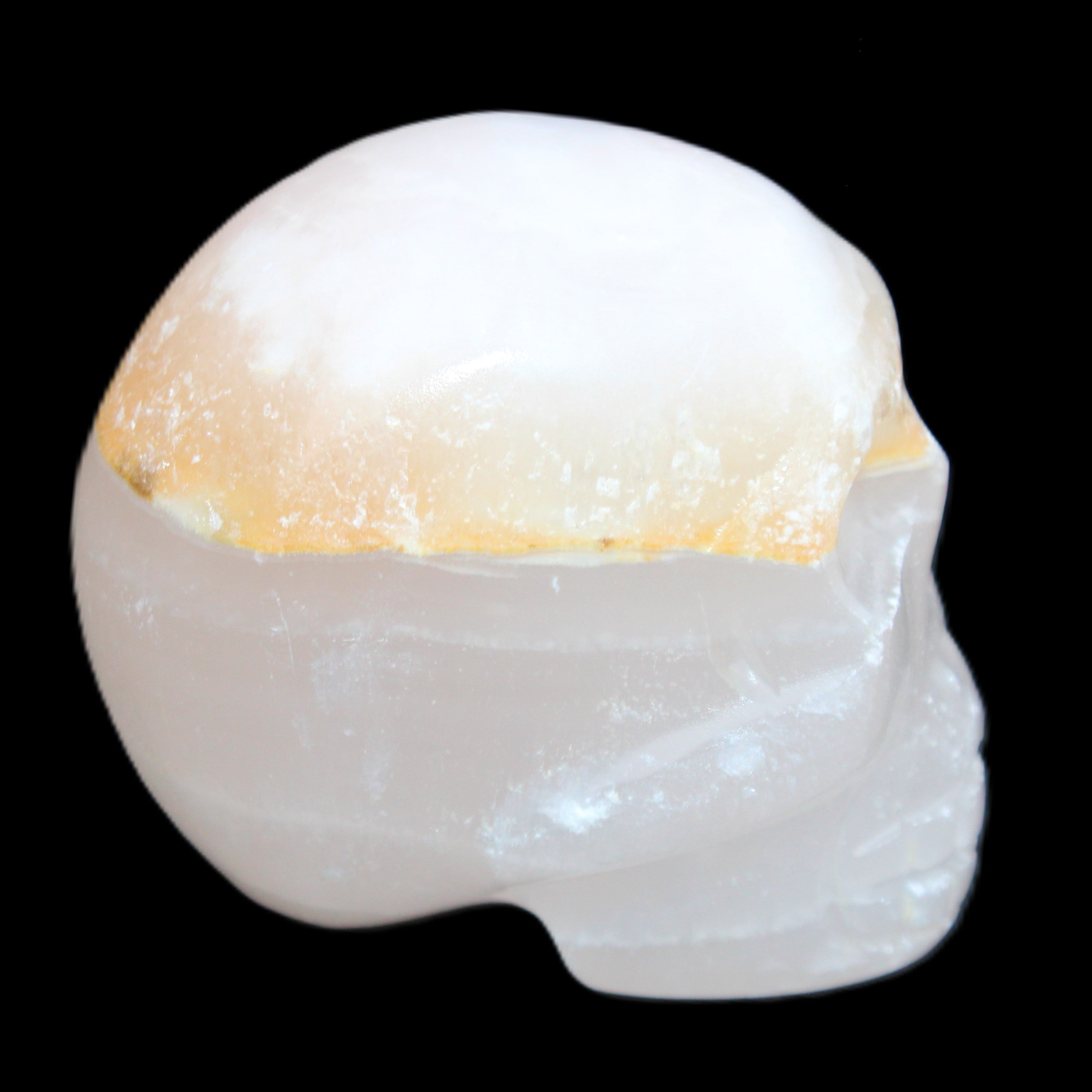 Mangano Calcite skull 38*55*48mm 167g in sunlight - Rocks and Things Store