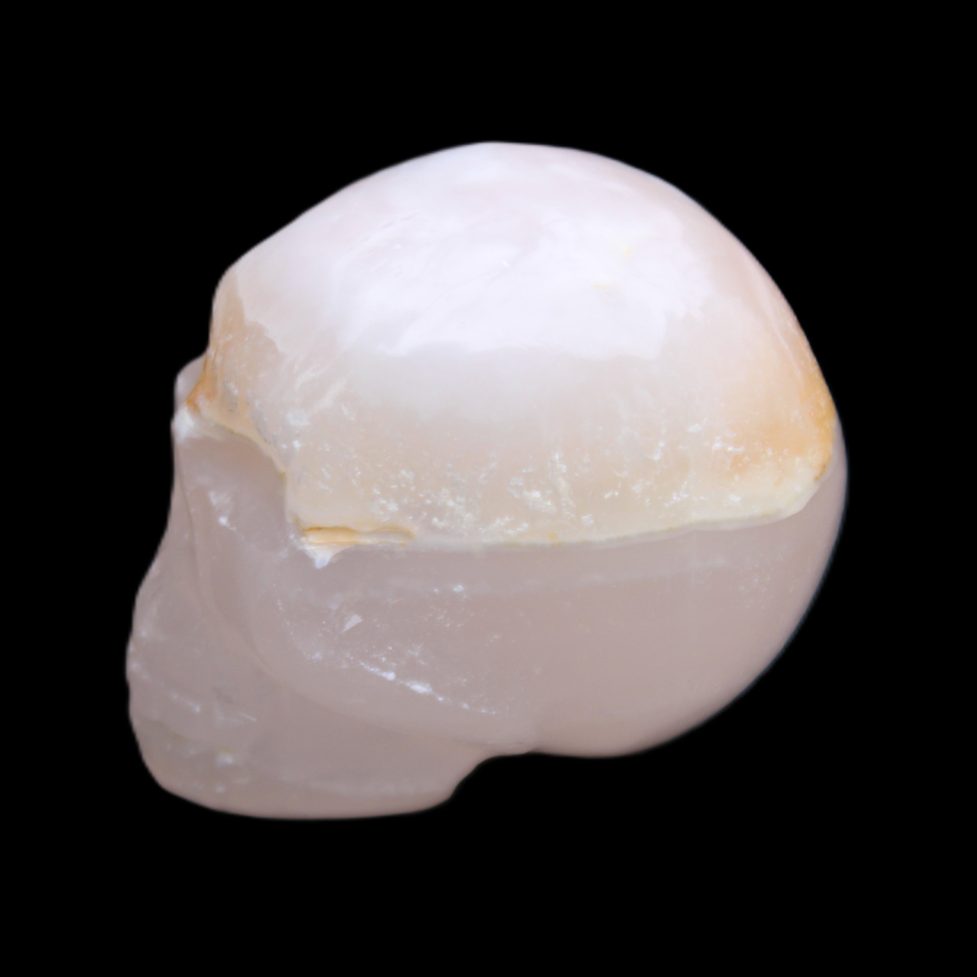 Mangano Calcite skull 38*55*48mm 167g in sunlight - Rocks and Things Store