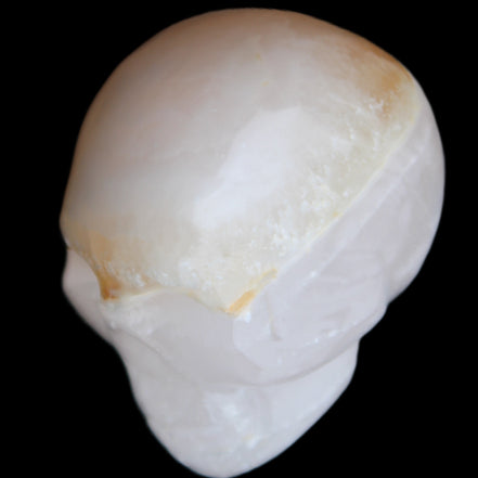 Mangano Calcite skull 38*55*48mm 167g in sunlight - Rocks and Things Store