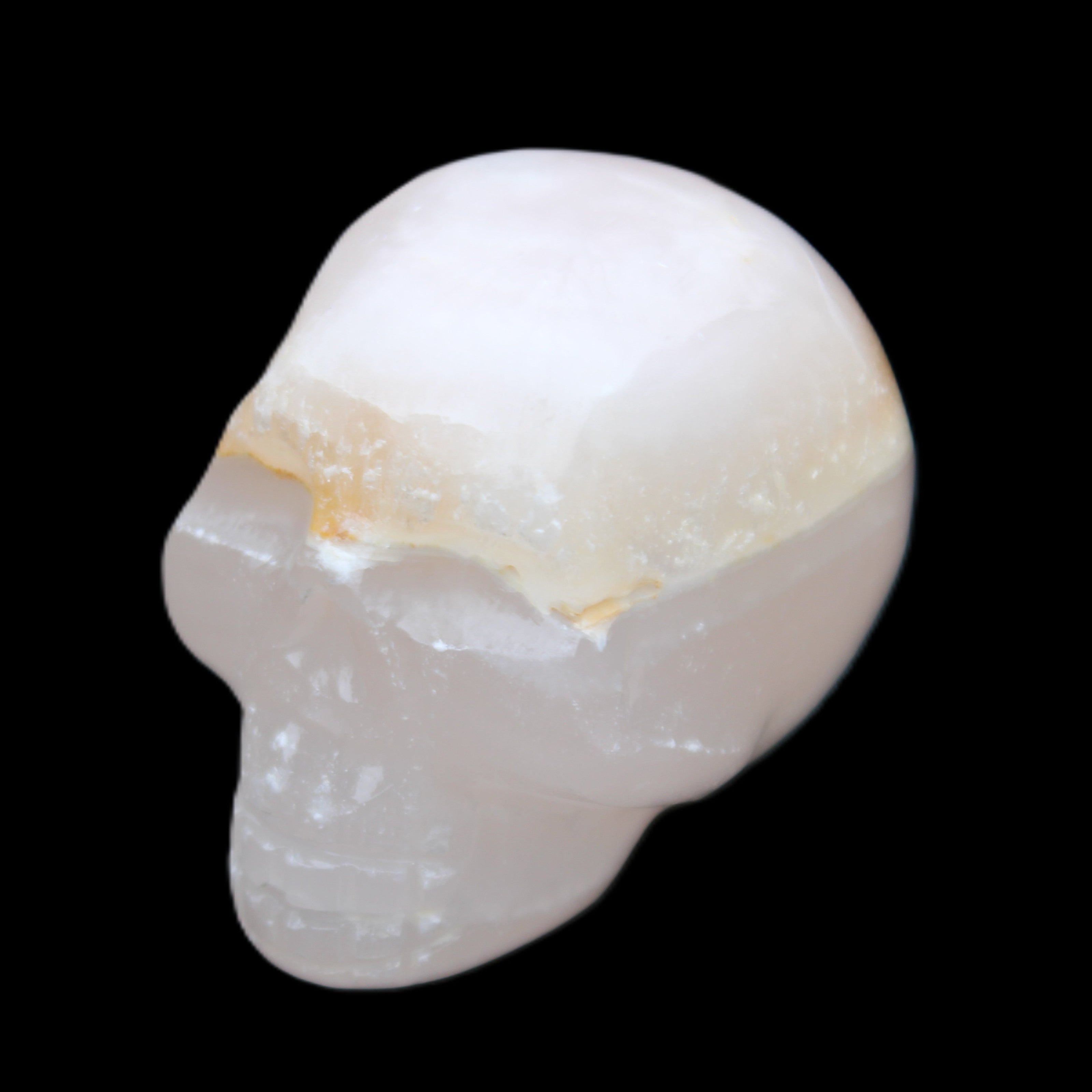Mangano Calcite skull 38*55*48mm 167g in sunlight - Rocks and Things Store
