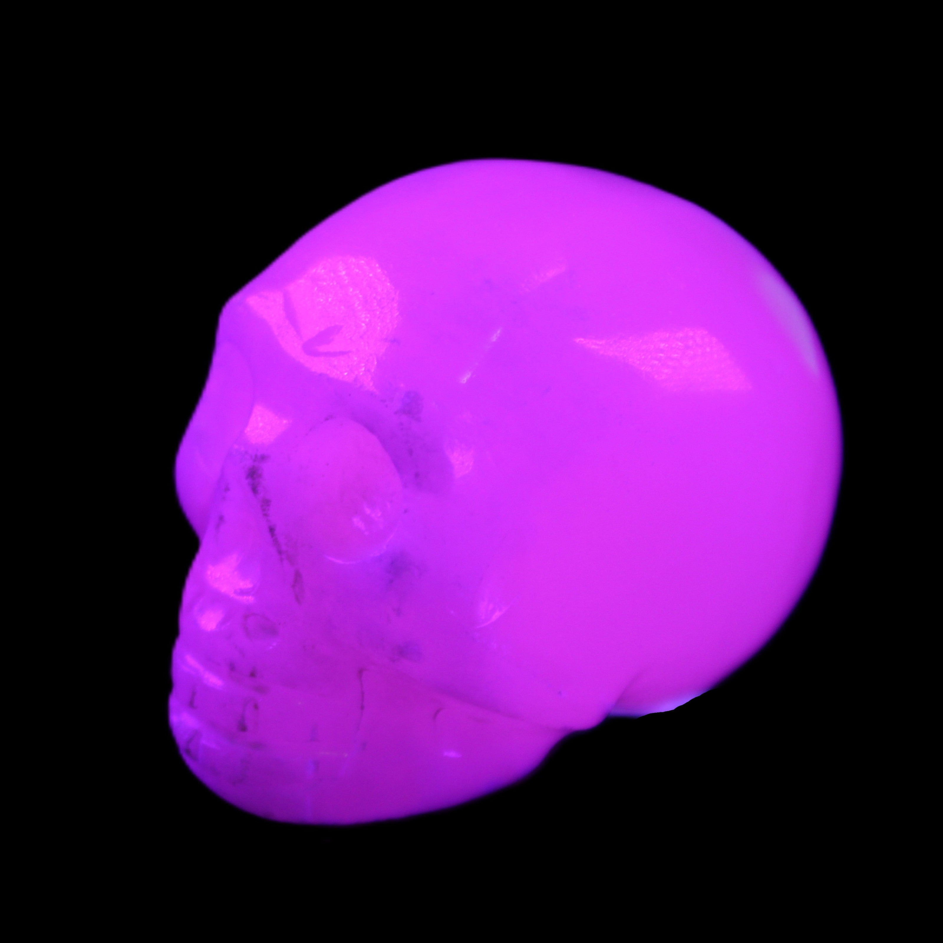 Mangano Calcite skull 32*45*38mm 87g in UV light - Rocks and Things Store