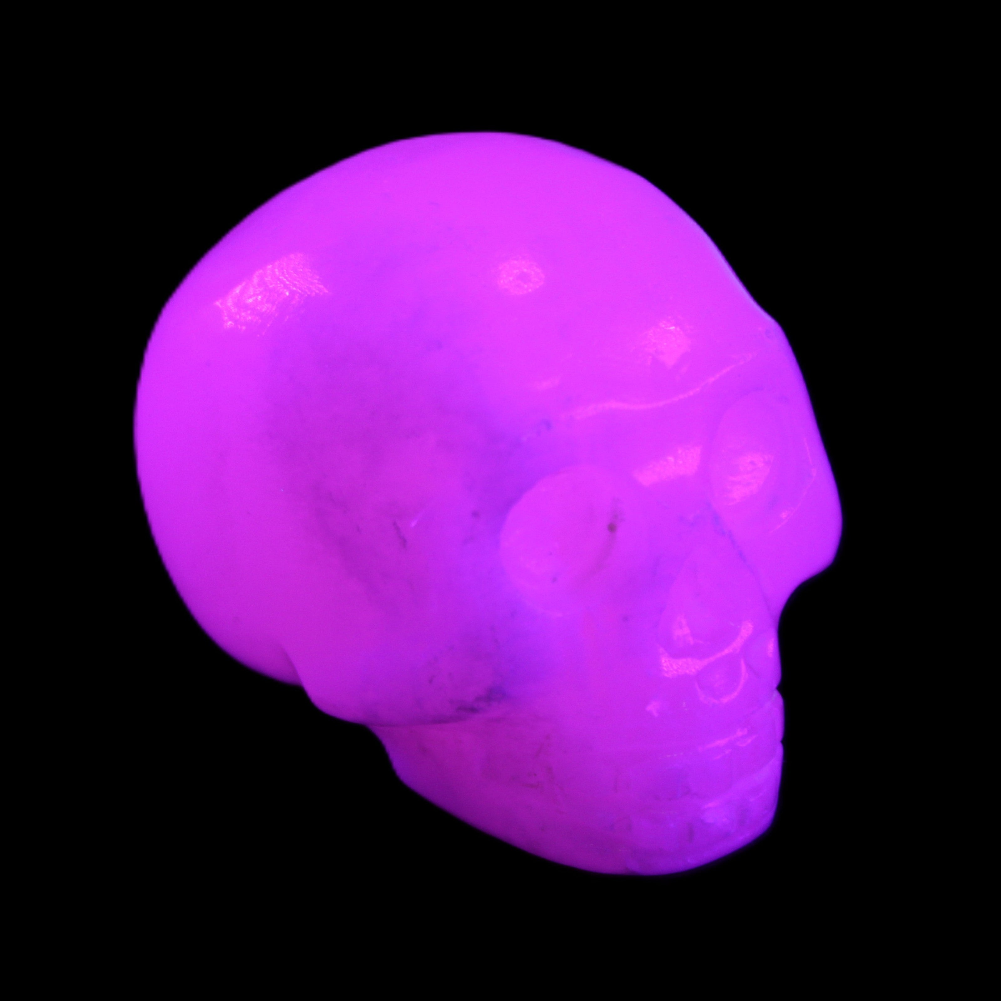Mangano Calcite skull 32*45*38mm 87g in UV light - Rocks and Things Store