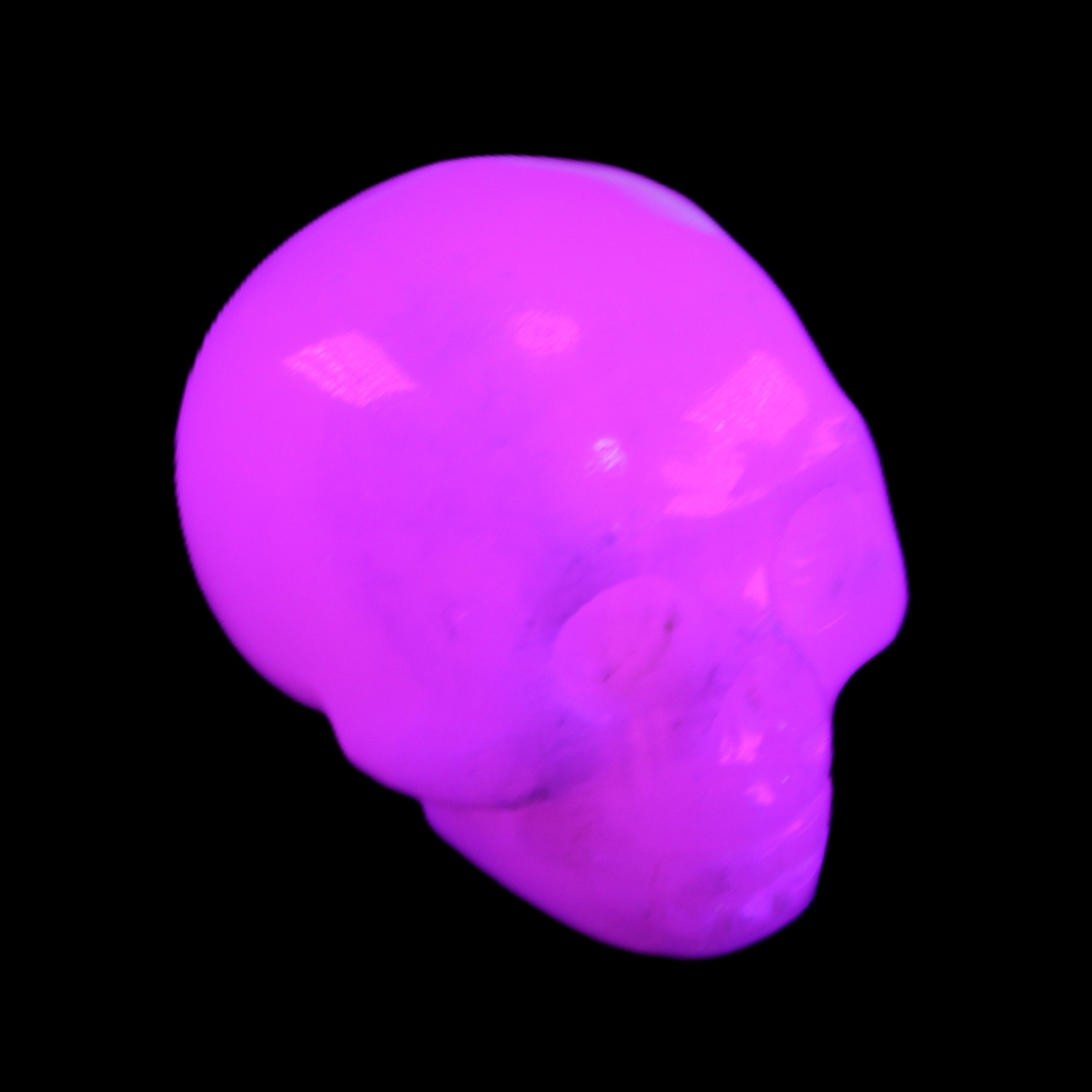 Mangano Calcite skull 32*45*38mm 87g in UV light - Rocks and Things Store