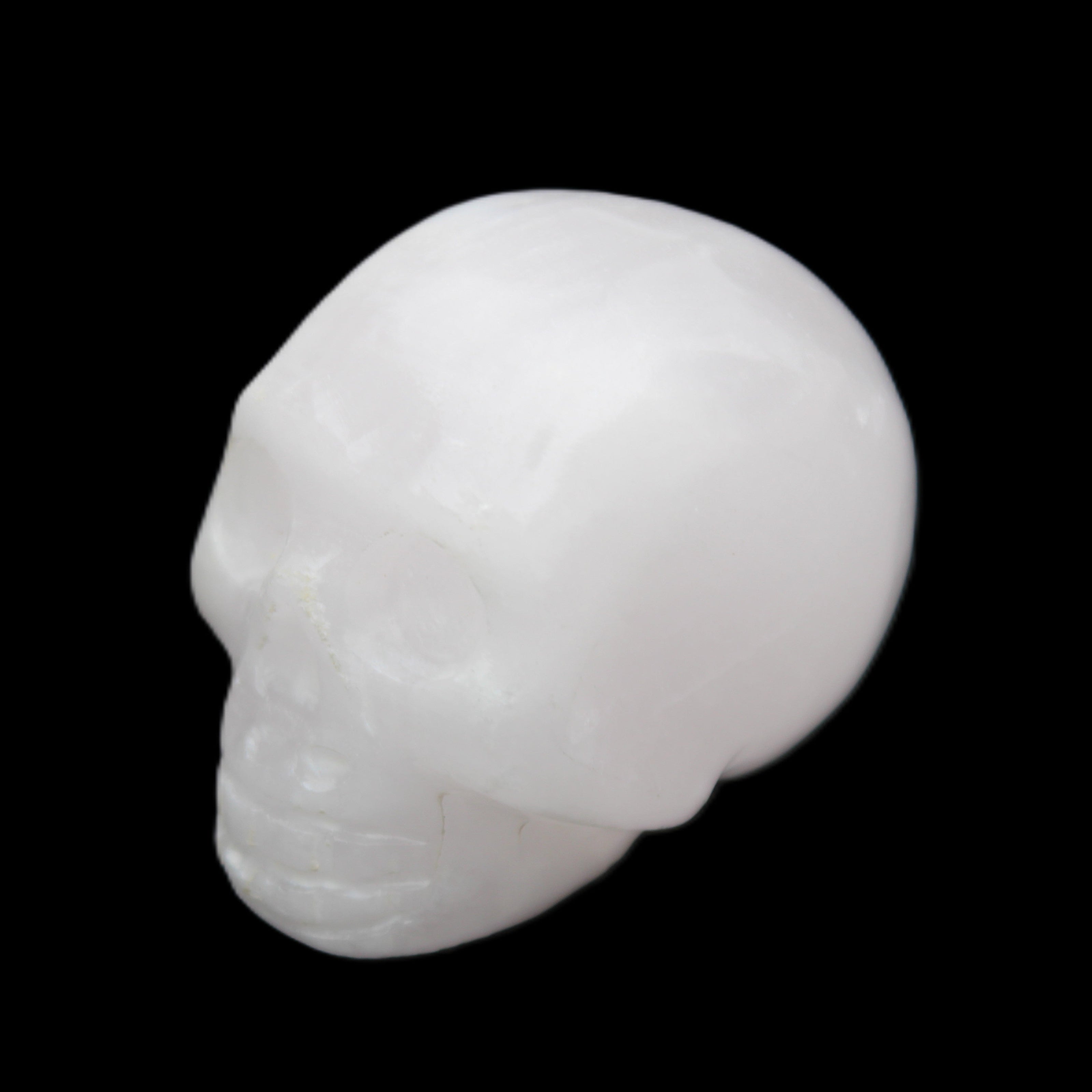 Mangano Calcite skull 32*45*38mm 87g in sunlight - Rocks and Things Store