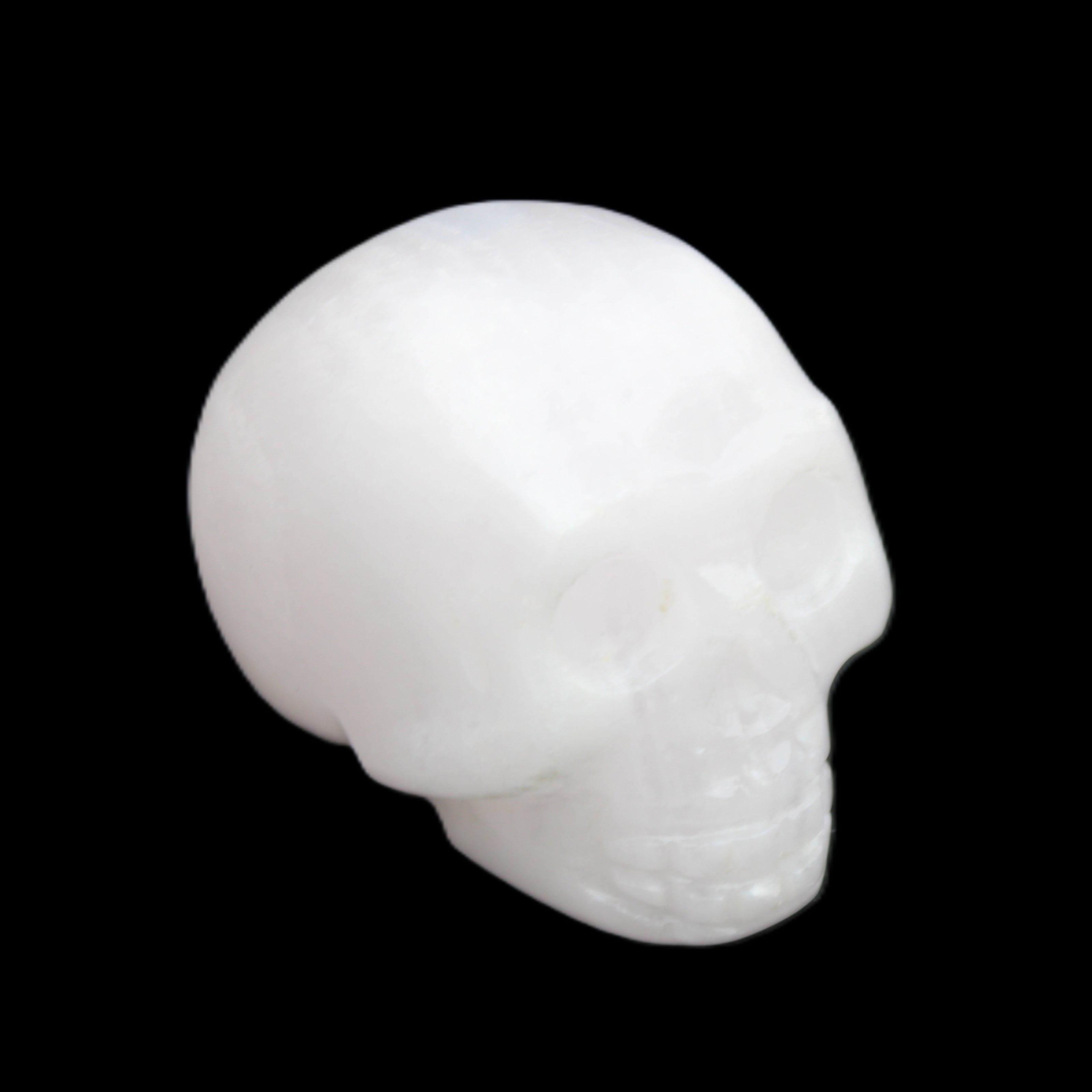 Mangano Calcite skull 32*45*38mm 87g in sunlight - Rocks and Things Store