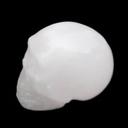 Mangano Calcite skull 32*45*38mm 87g in sunlight - Rocks and Things Store