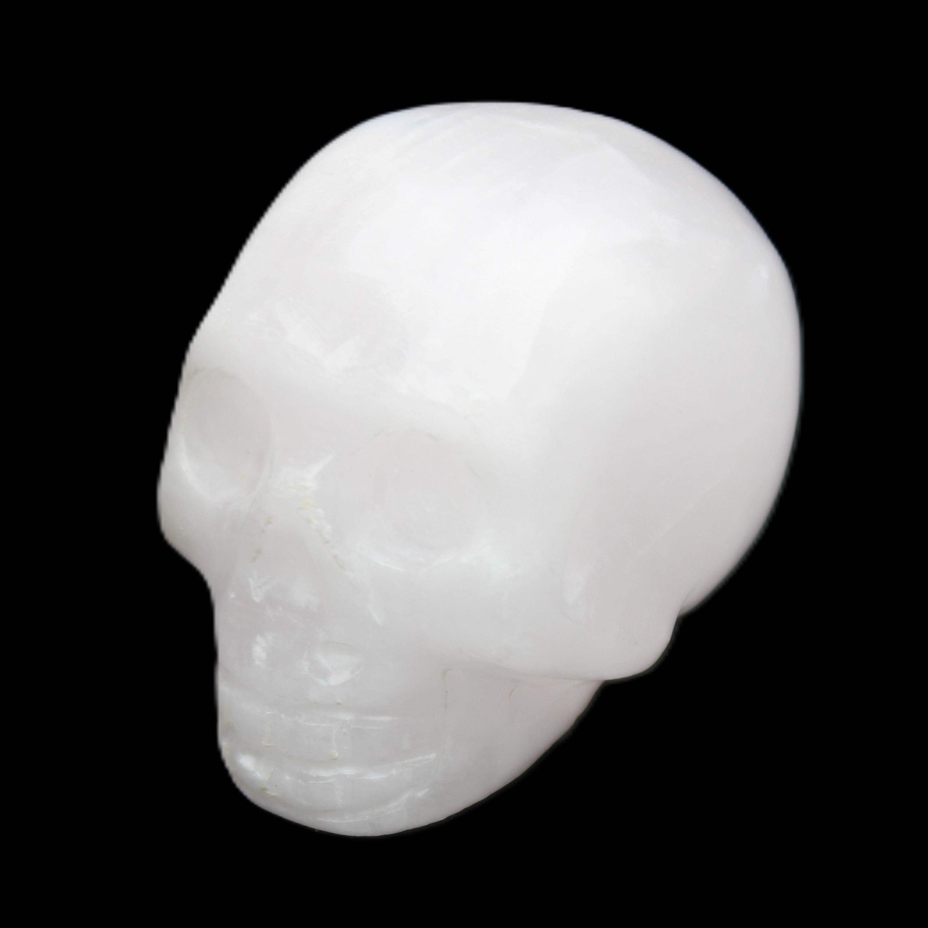 Mangano Calcite skull 32*45*38mm 87g in sunlight - Rocks and Things Store