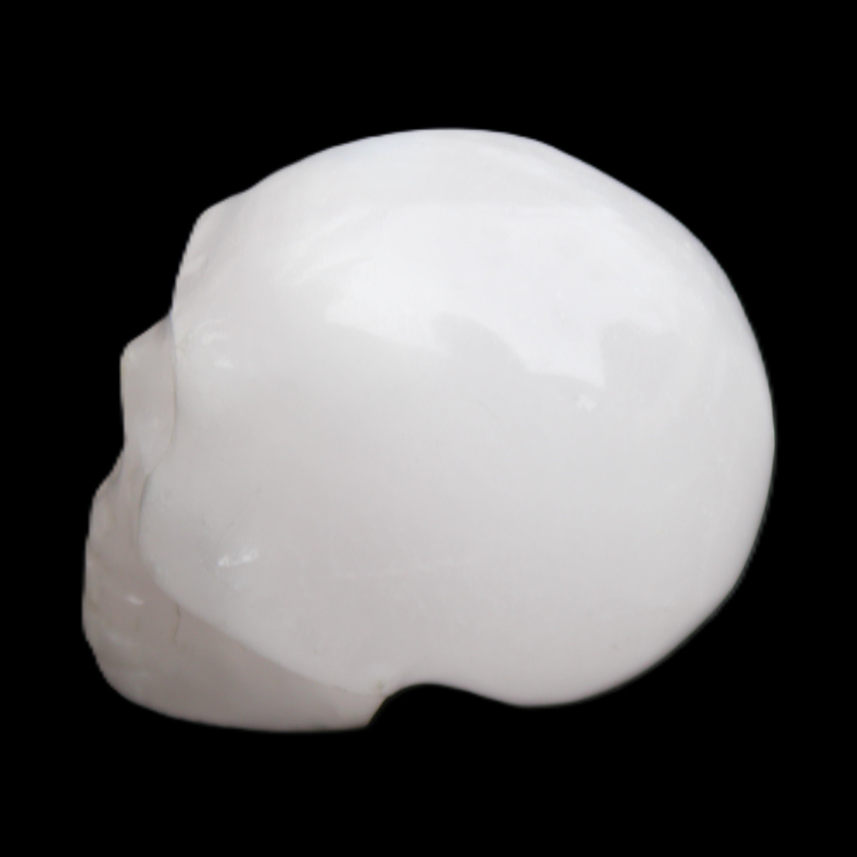 Mangano Calcite skull 32*45*38mm 87g in sunlight - Rocks and Things Store