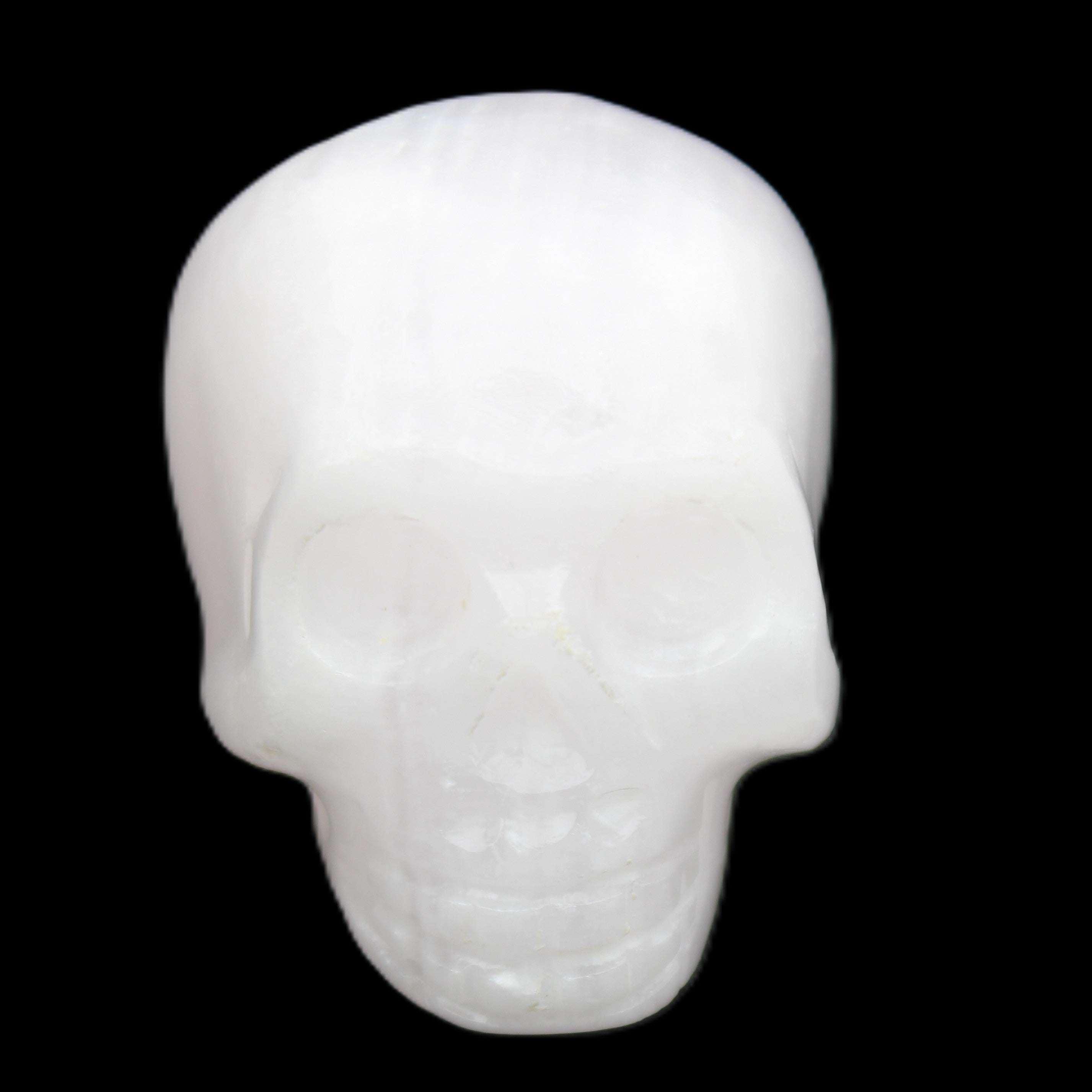 Mangano Calcite skull 32*45*38mm 87g in sunlight - Rocks and Things Store