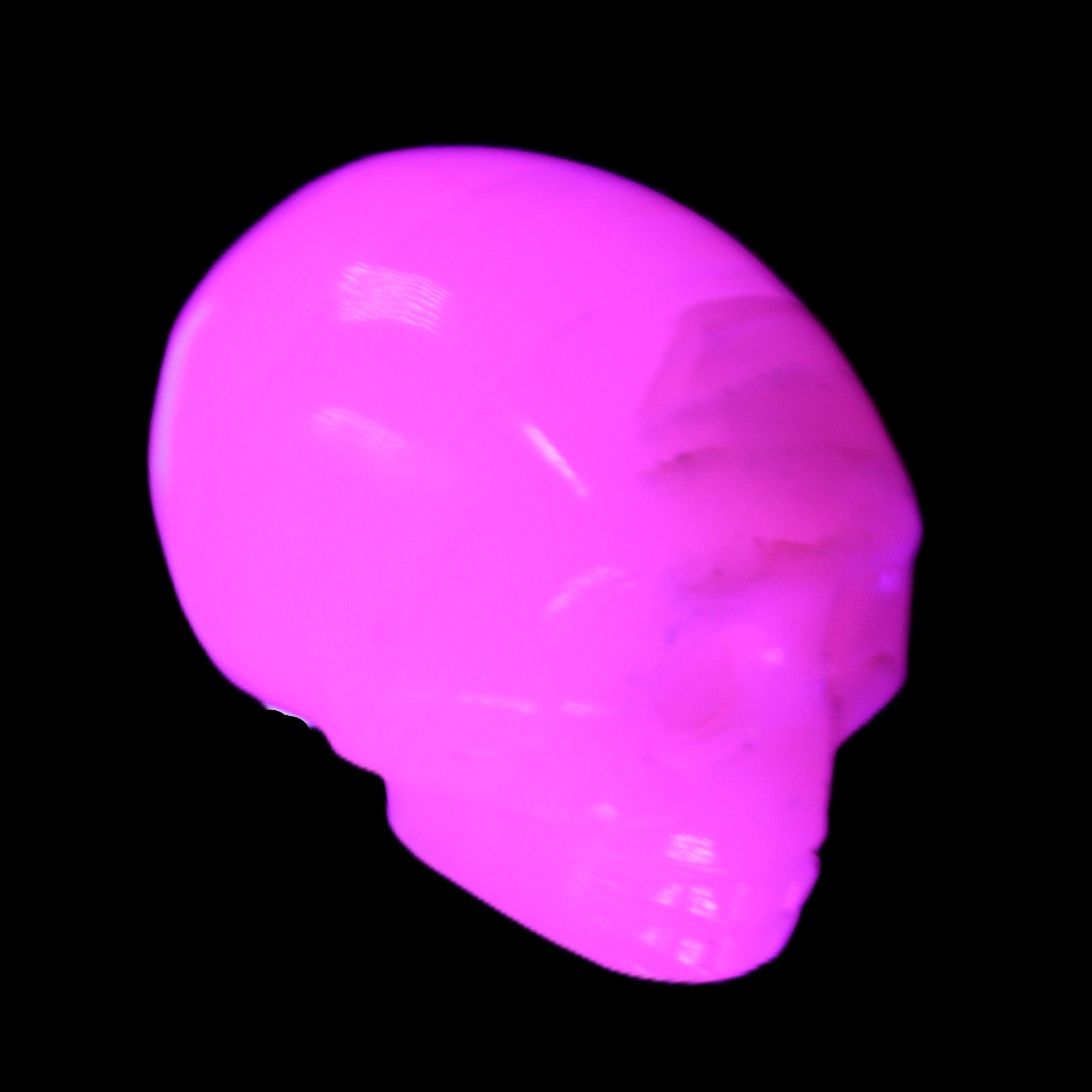 Mangano Calcite skull 28*45*35mm 81g in UV light - Rocks and Things Store