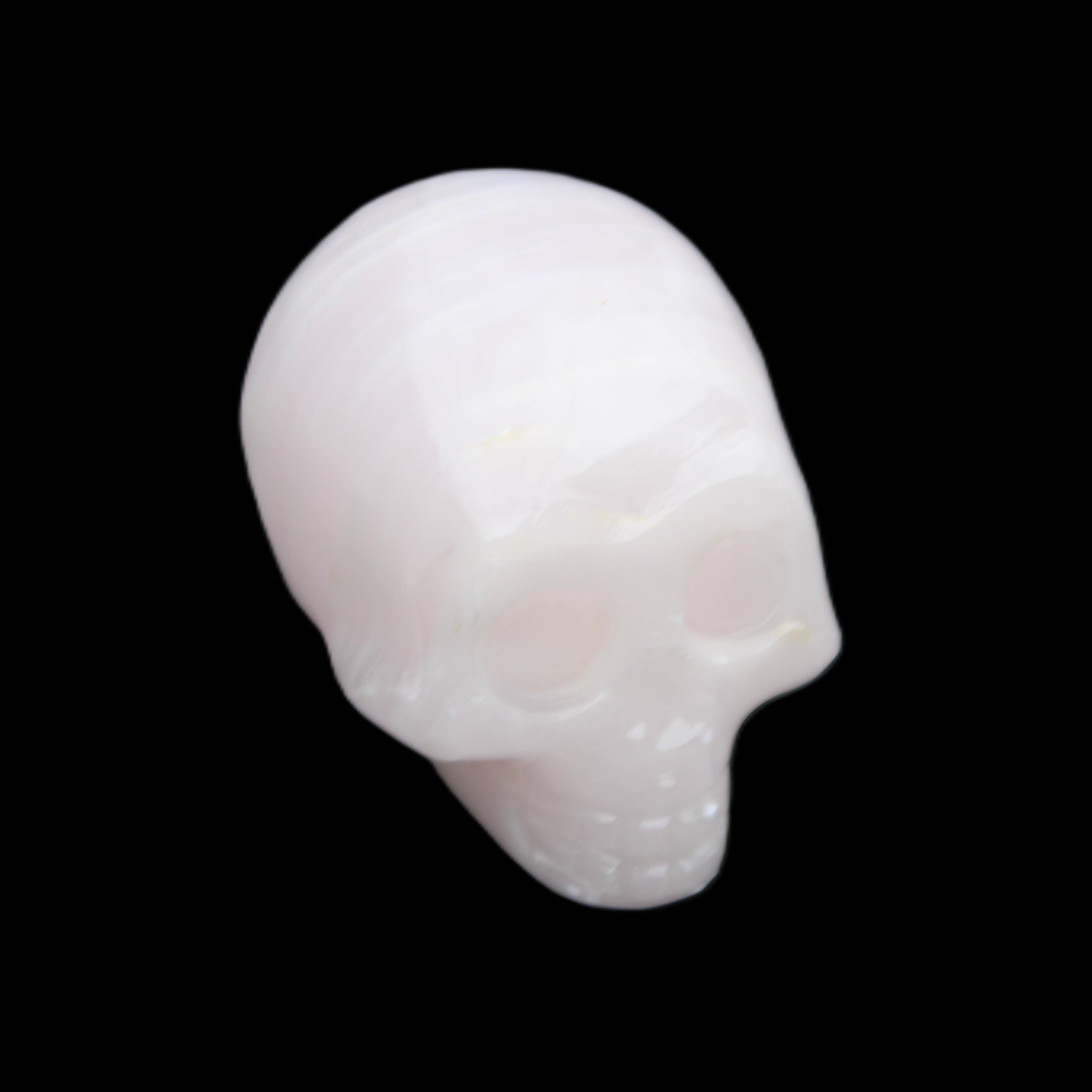 Mangano Calcite skull 28*45*35mm 81g in sunlight - Rocks and Things Store