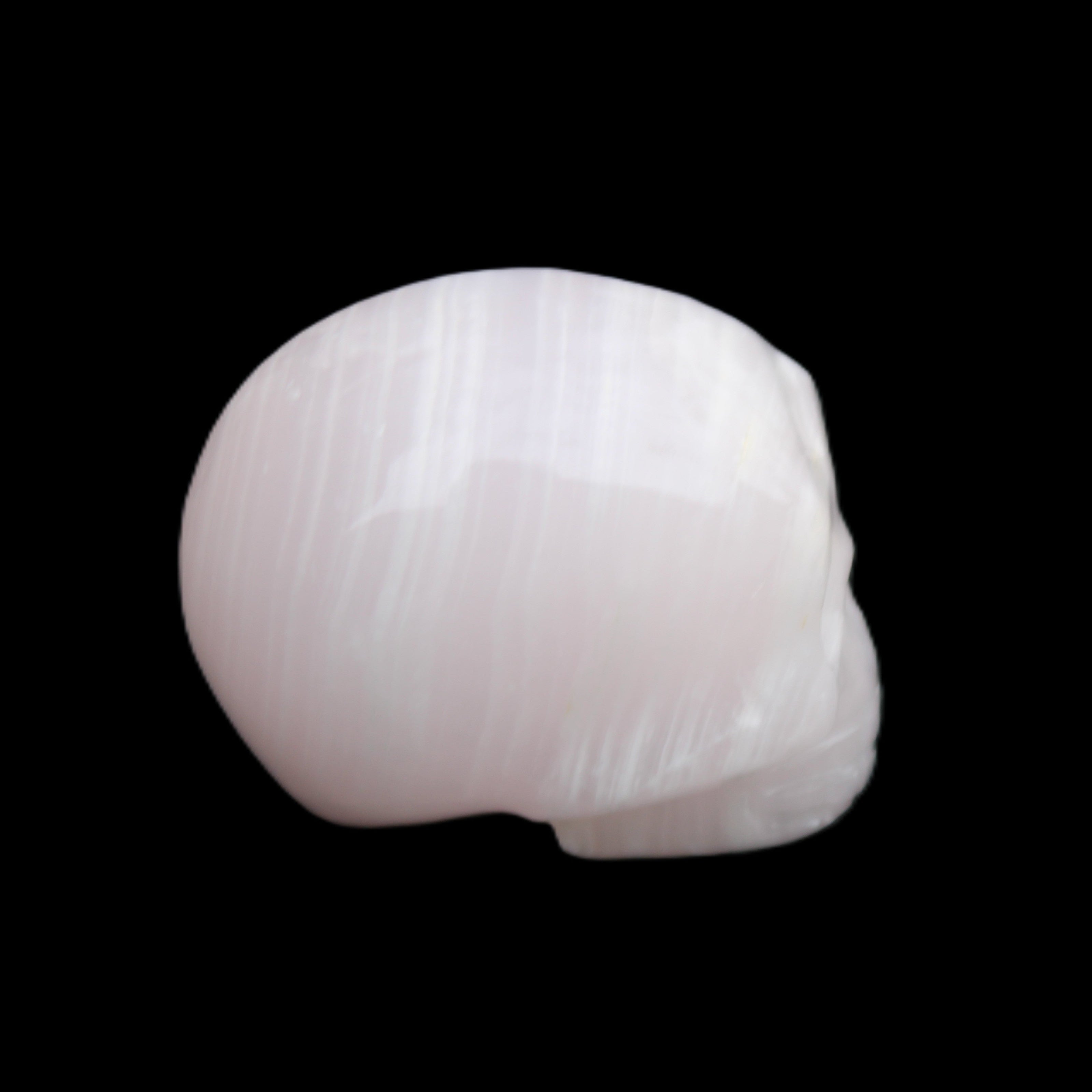 Mangano Calcite skull 28*45*35mm 81g in sunlight - Rocks and Things Store