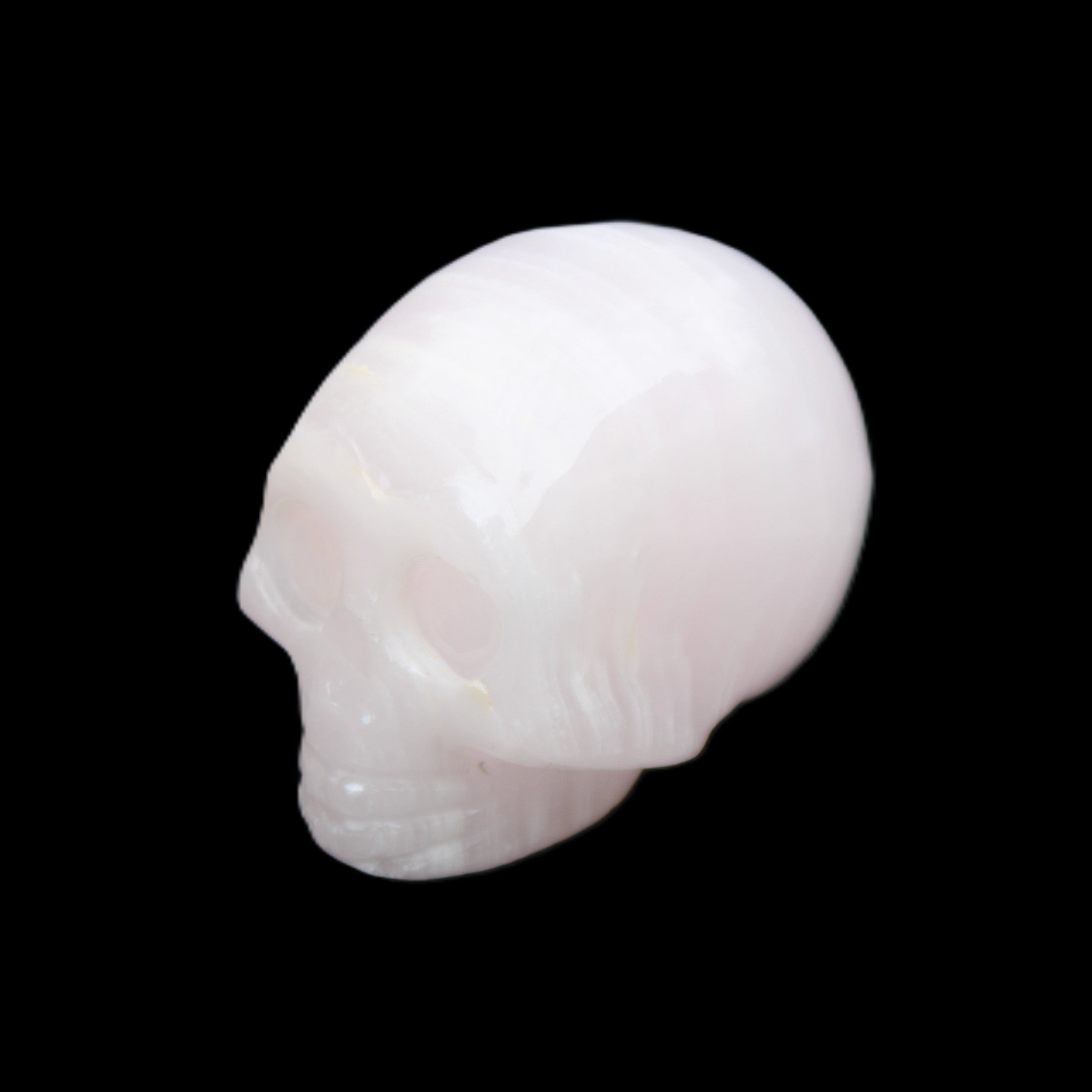 Mangano Calcite skull 28*45*35mm 81g in sunlight - Rocks and Things Store