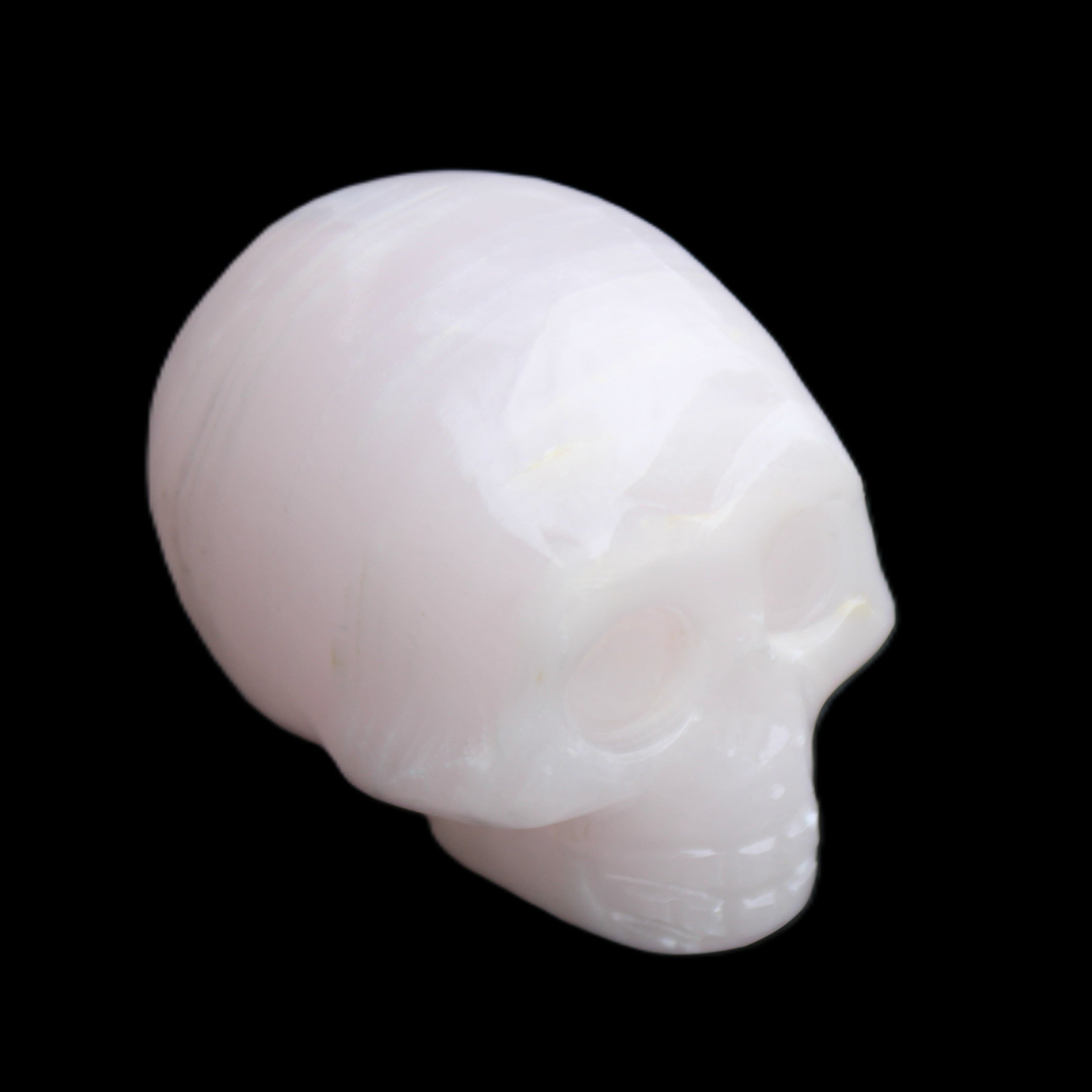 Mangano Calcite skull 28*45*35mm 81g in sunlight - Rocks and Things Store