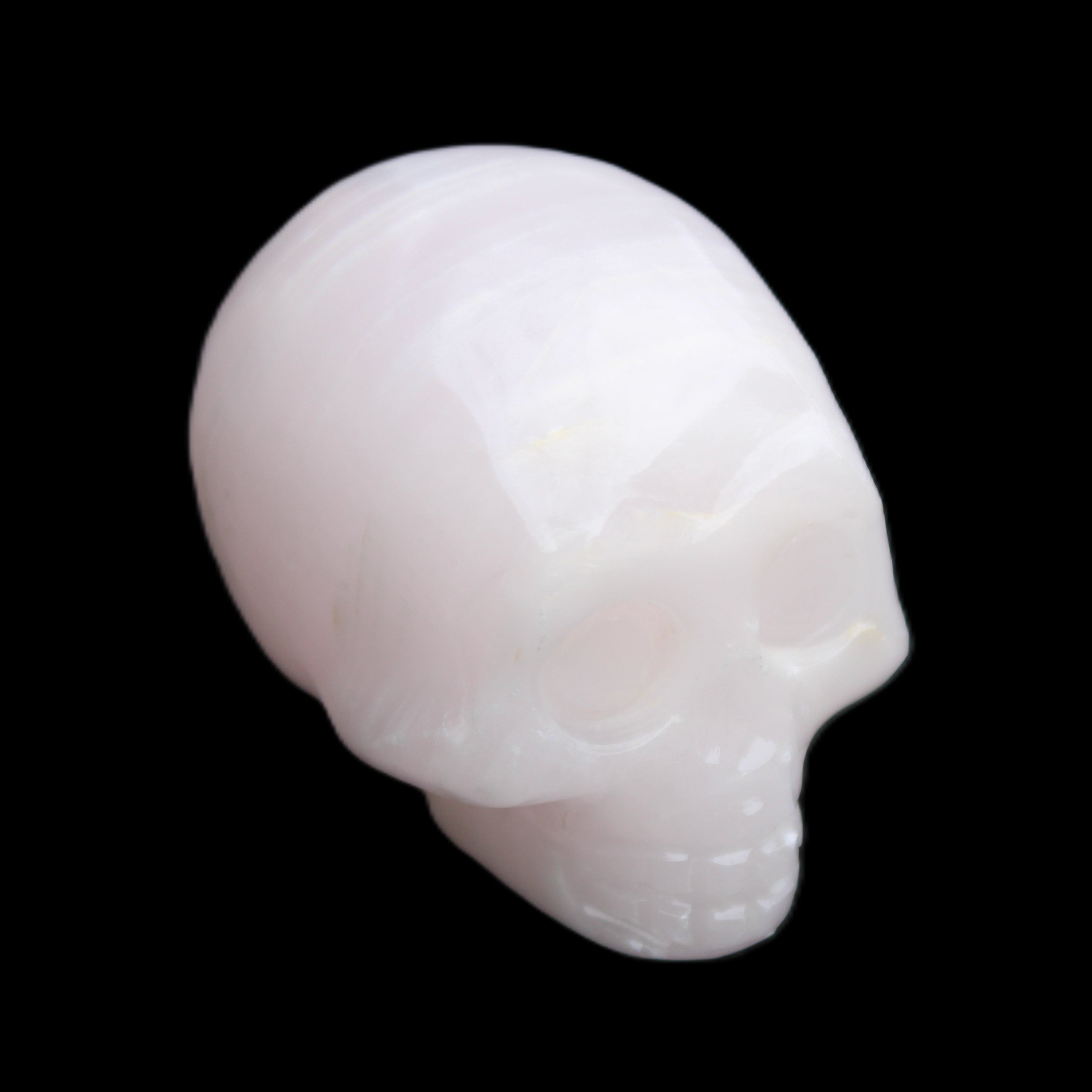 Mangano Calcite skull 28*45*35mm 81g in sunlight - Rocks and Things Store