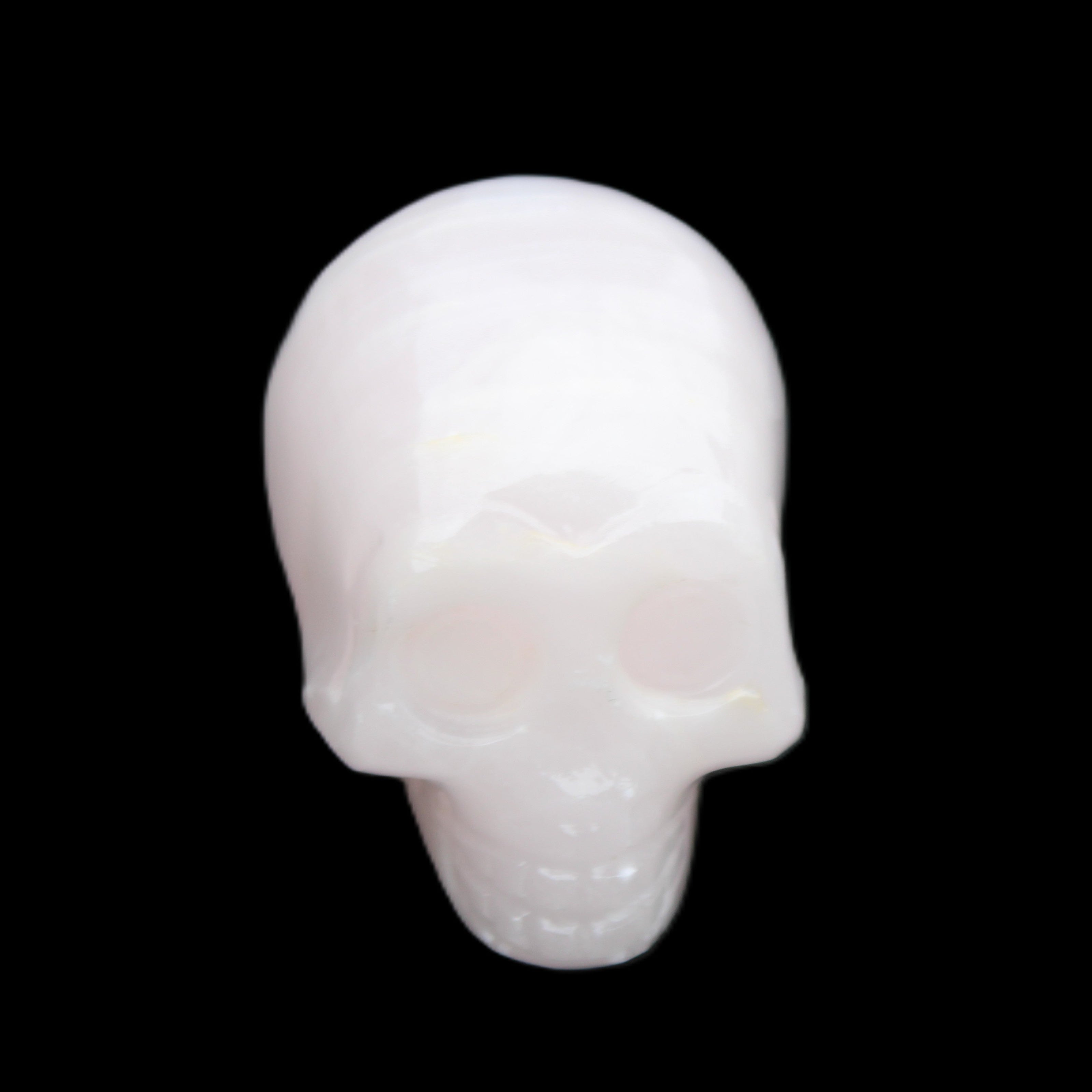 Mangano Calcite skull 28*45*35mm 81g in sunlight - Rocks and Things Store