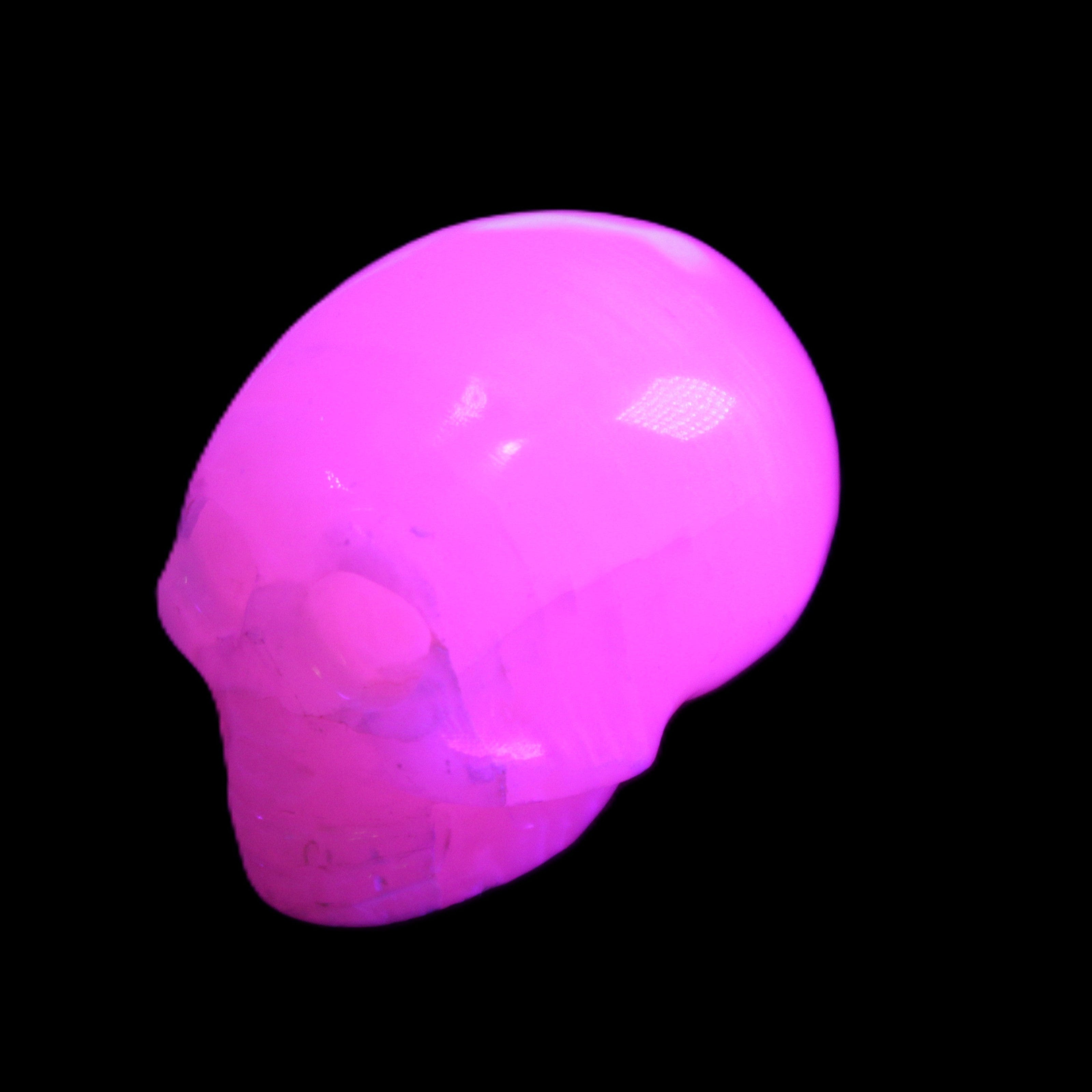Mangano Calcite skull 30*47*35mm 81g in UV light - Rocks and Things Store